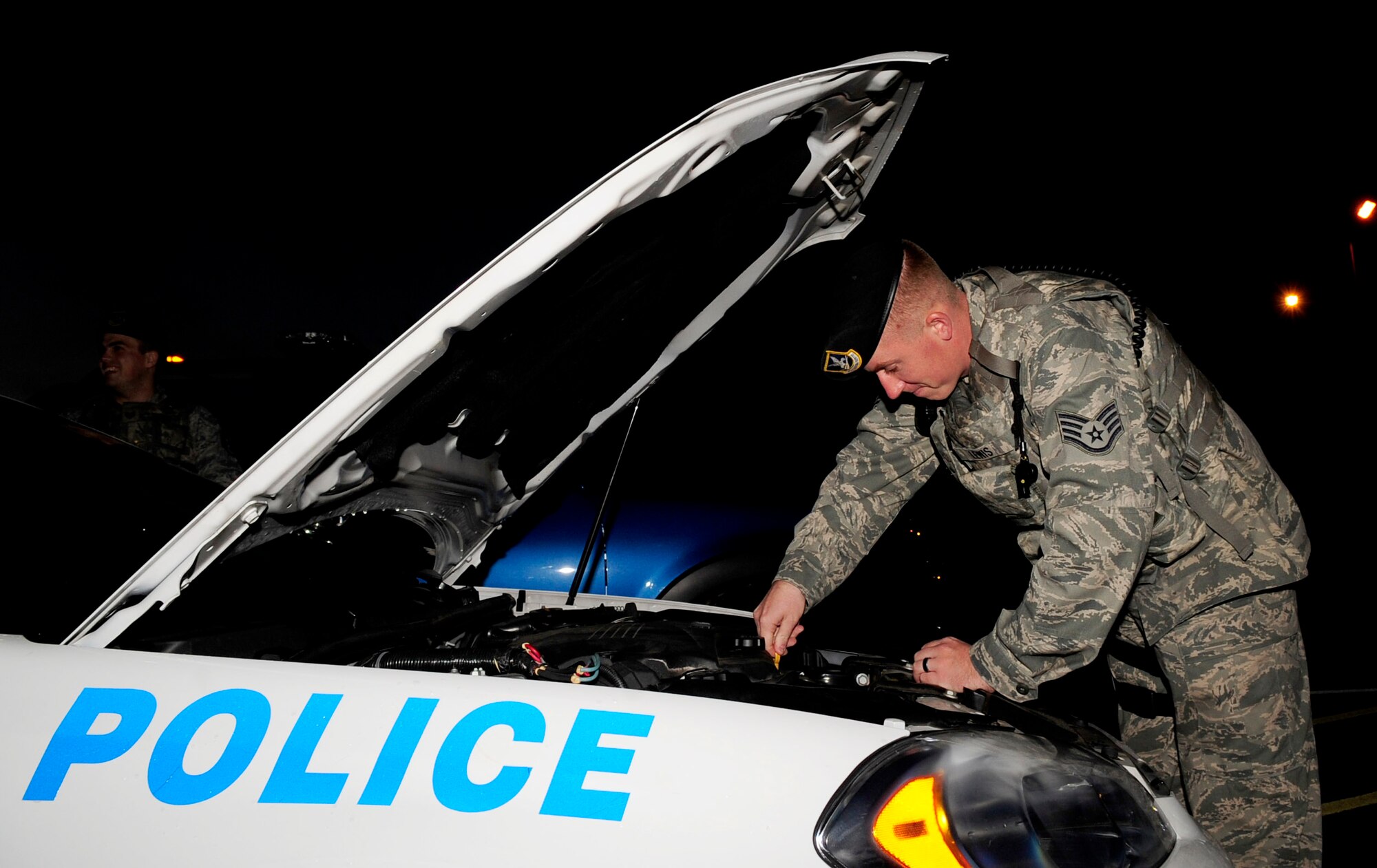 RAF MILDENHALL, England -- Staff Sgt. Benjamin Lewis, 100th Security Forces Squadron response force leader, performs a function check on a patrol car during its change-over to him at the beginning of his shift at RAF Mildenhall Aug. 15, 2012. The 100th SFS patrol cars are used by each shift of Airmen and receive a change-over inspection before being passed on to the next patrolman. (U.S. Air Force photo/Senior Airman Ethan Morgan)