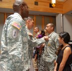 San Antonio Recruiting Battalion commander Lt. Col. David A. Grant looks on as Maj. Gen. David L. Mann, U.S. Army Recruiting Command commanding general, presents the Army Commendation Medal to Sgt. 1st Class David A. Mendoza for a lifesaving action. (U.S. Army Photo by Lisa Masters)
