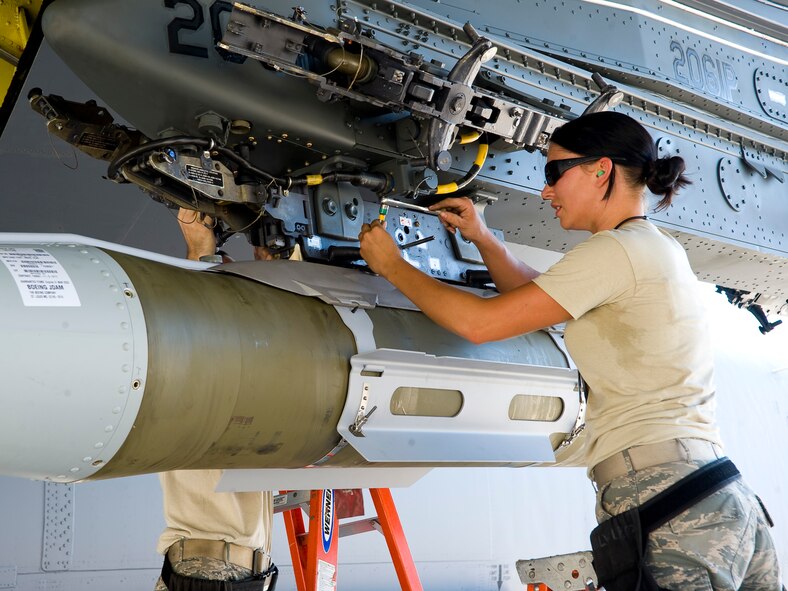 Senior Airman Erin Bernik, 2nd Maintenance Operations Squadron weapons standardization section, attaches an inert GBU-31 joint direct attack munition to a heavy storage adapter beam under the wing of a B-52H Stratofortress on Barksdale Air Force Base, La., Aug 14. The HSAB contains connections that allow the aircraft to communicate with the computer systems in the smart bombs. The weapon load is part of exercise Combat Hammer, meant to evaluate the generation and employment of guided munitions. (U.S. Air Force photo/Staff Sgt. Chad Warren)(RELEASED)
