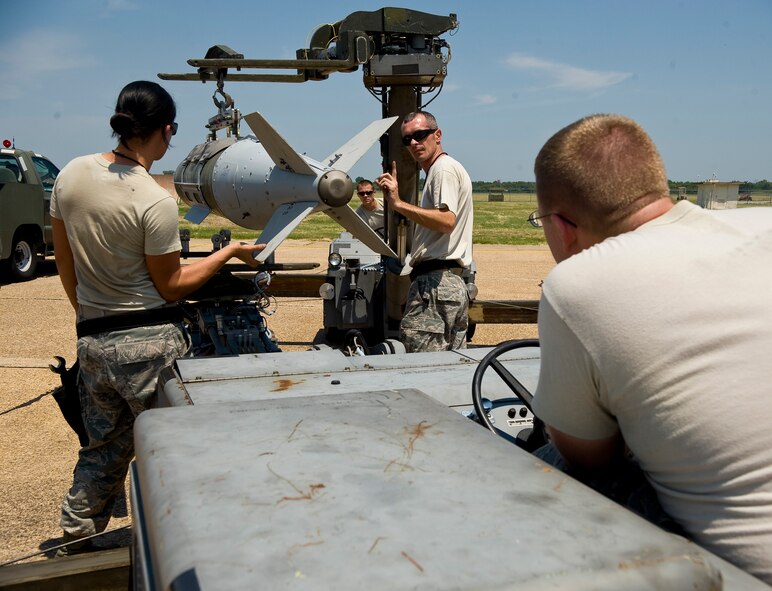 Airmen from the 2nd Maintenance Operations Squadron weapons standardization section maneuver an inert GBU-31 joint direct attack munition before loading it onto a B-52H Stratofortress on Barksdale Air Force Base, La., Aug 14. The JDAM is equipped with telemetry which provides feedback about the bomb's trajectory and speed. The weapon load is part of exercise Combat Hammer, meant to evaluate the generation and employment of guided munitions. (U.S. Air Force photo/Staff Sgt. Chad Warren)(RELEASED)