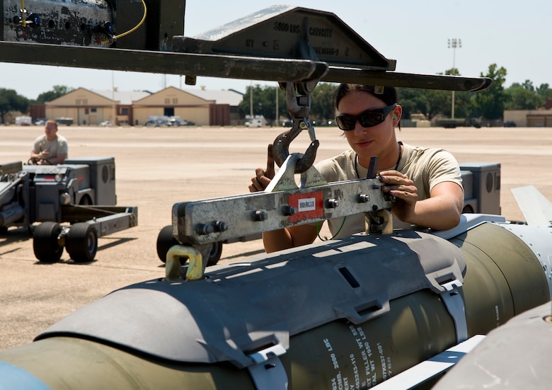 Senior Airman Erin Bernik, 2nd Maintenance Operations Squadron weapons standardization section, attaches an inert GBU-31 joint direct attack munition to a lift on Barksdale Air Force Base, La., Aug 14. The bombs are being loaded onto a B-52H Stratofortress to be dropped at a bombing range in Utah as part of exercise Combat Hammer. (U.S. Air Force photo/Staff Sgt. Chad Warren)(RELEASED)