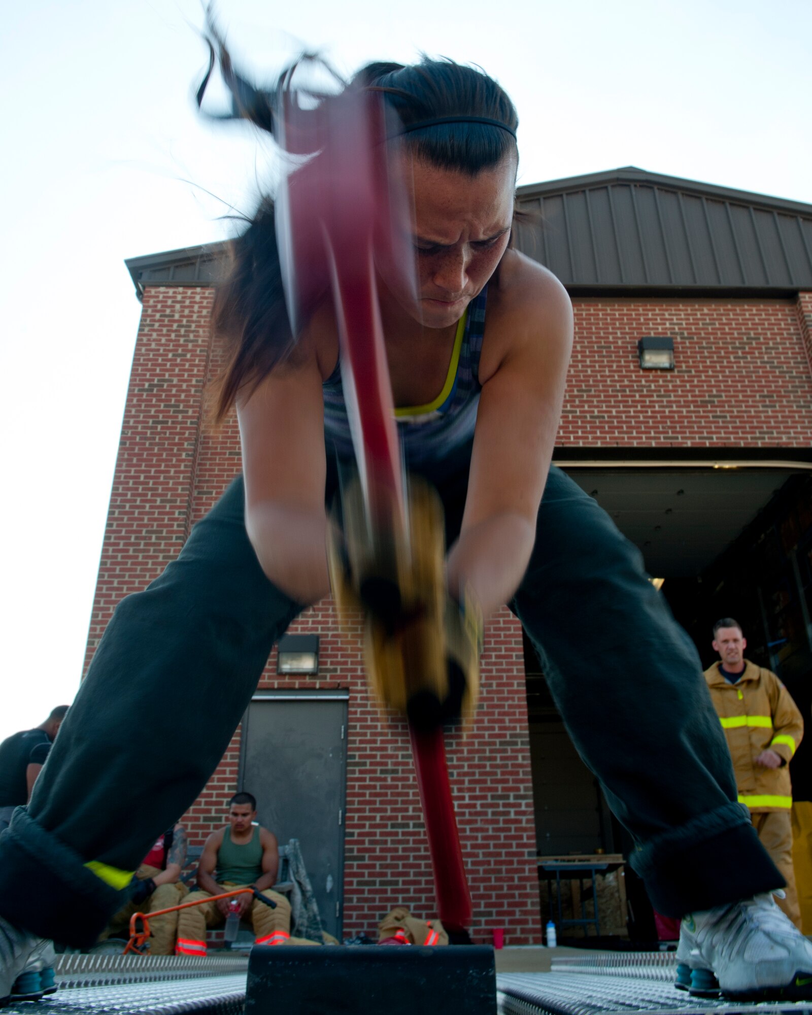 Staff Sgt. Kira Enlow, 633rd Civil Engineer Squadron firefighter, uses a 10-pound hammer to move a 160-pound sled Aug. 14, 2012, at Langley Air Force Base, Va. Enlow is on a team composed of seven 633rd CES firefighters who will take part in a regional Firefighter Combat Challenge, Aug. 17 and 18, 2012, in Charleston, W.Va. (U.S. Air Force photo by Airman 1st Class R. Alex Durbin/Released)