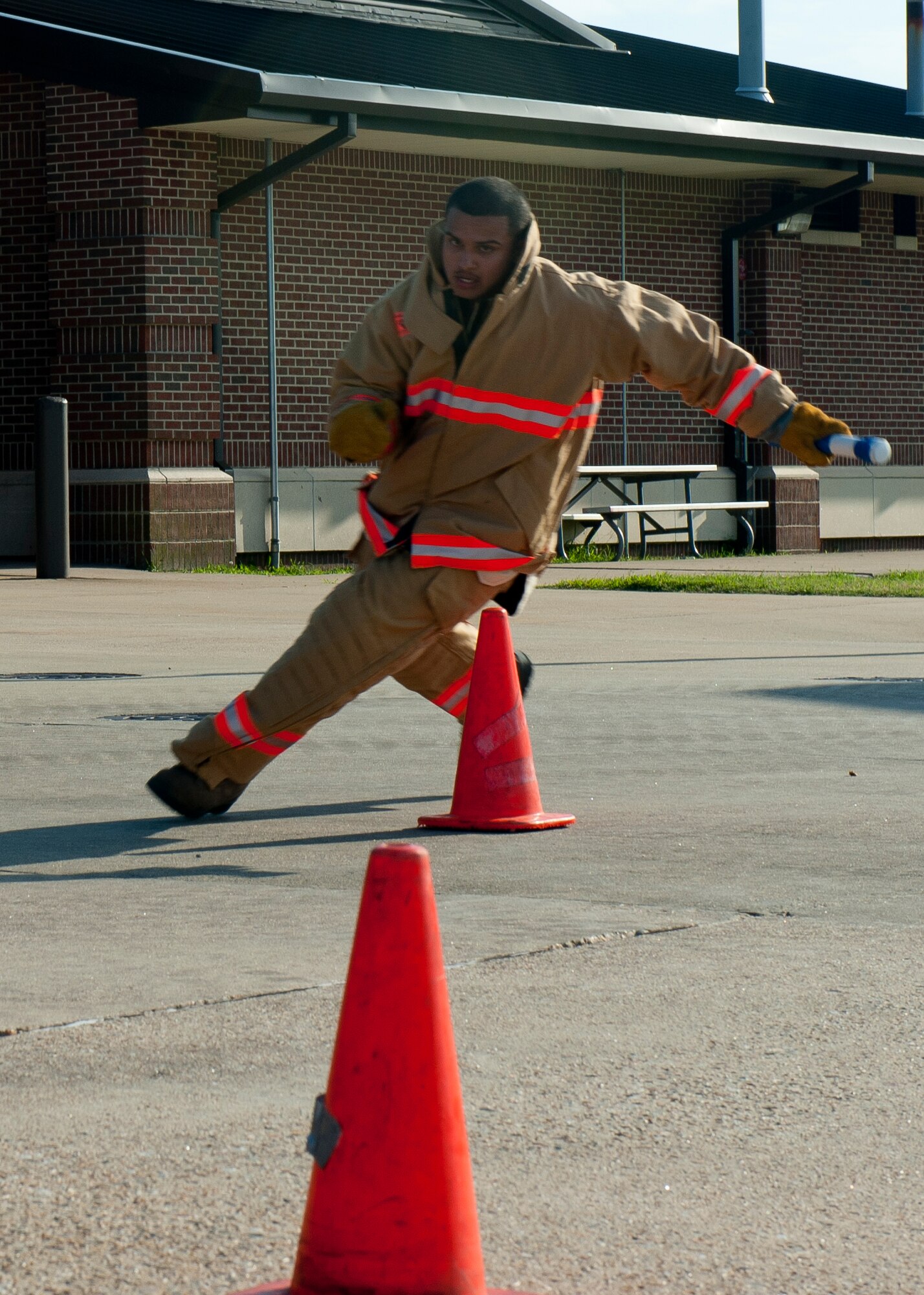 Airman 1st Class Chrisili Villasenor, 633rd Civil Engineer Squadron firefighter, runs the cone slalom during the last Fire Fighter Challenge team practice, Aug. 14, 2012, at Langley Air Force Base, Va. The team hopes to qualify for the national challenge, which annually attracts hundreds of fire departments from more than 25 locations, and is expanding to countries around the world. (U.S. Air Force photo by Airman 1st Class R. Alex Durbin/Released)