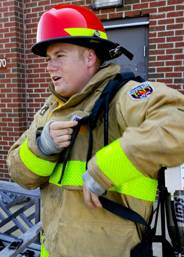 Staff Sgt. Jeremy Jones, 633rd Civil Engineer Squadron crew chief and team captain, suits up in full gear before starting practice, Aug. 13, 2012, at Langley Air Force Base, Va. Wearing "full bunker gear" and a breathing apparatus, pairs of competitors will race head-to-head as they simulate the physical demands of real-life firefighting. (U.S. Air Force photo by Airman 1st Class R. Alex Durbin/Released)
