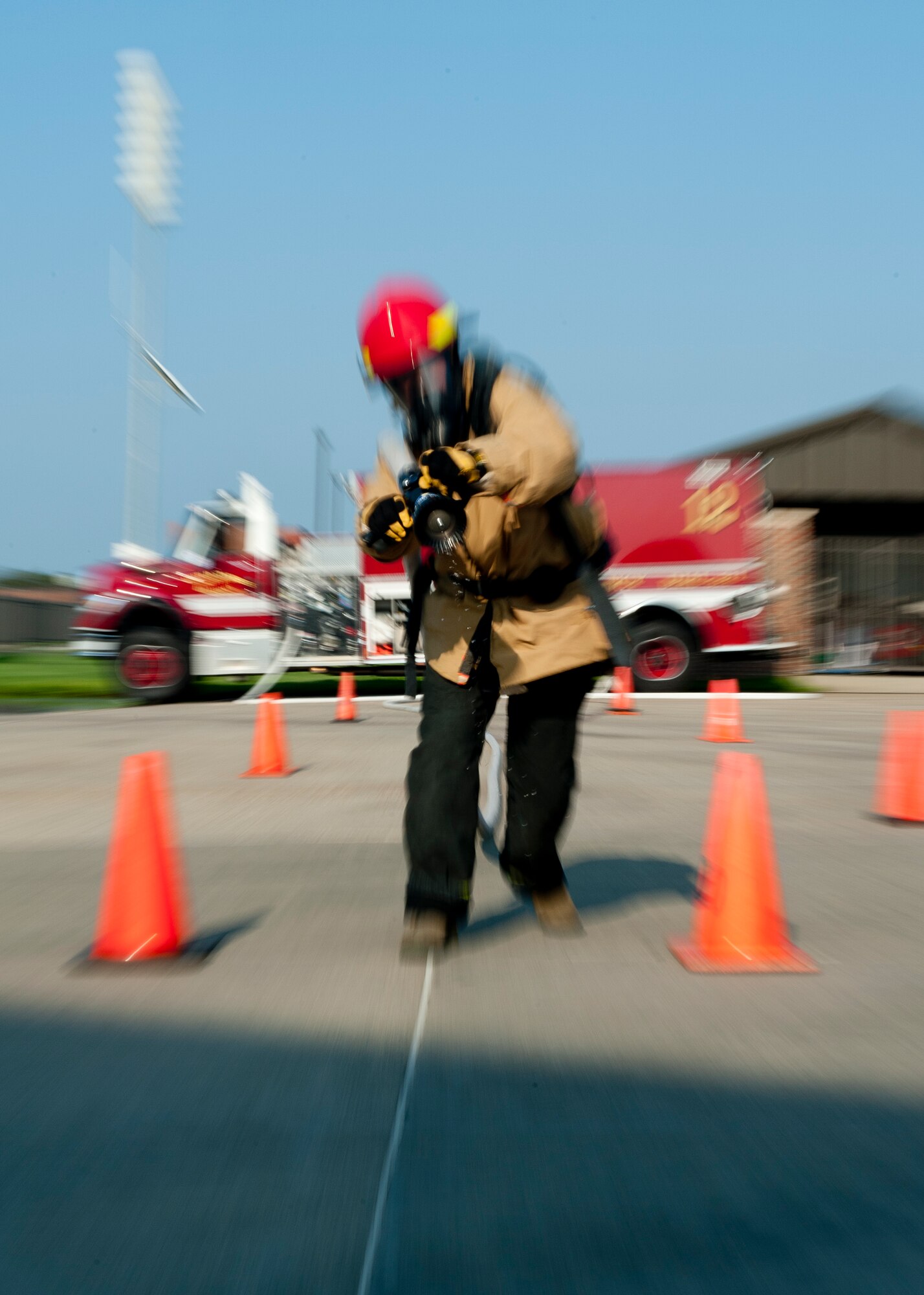 Staff Sgt. Kira Enlow, 633rd Civil Engineer Squadron firefighter, prepares to fire a hose during a Firefighter Challenge team run-through of the individual medley, Aug. 13, 2012, at Langley Air Force Base, Va. The 2012 World Firefighter Combat Challenge is scheduled to be held at Myrtle Beach, S.C., Nov. 12 through 17. (U.S. Air Force photo by Senior Airman John Strong/Released)