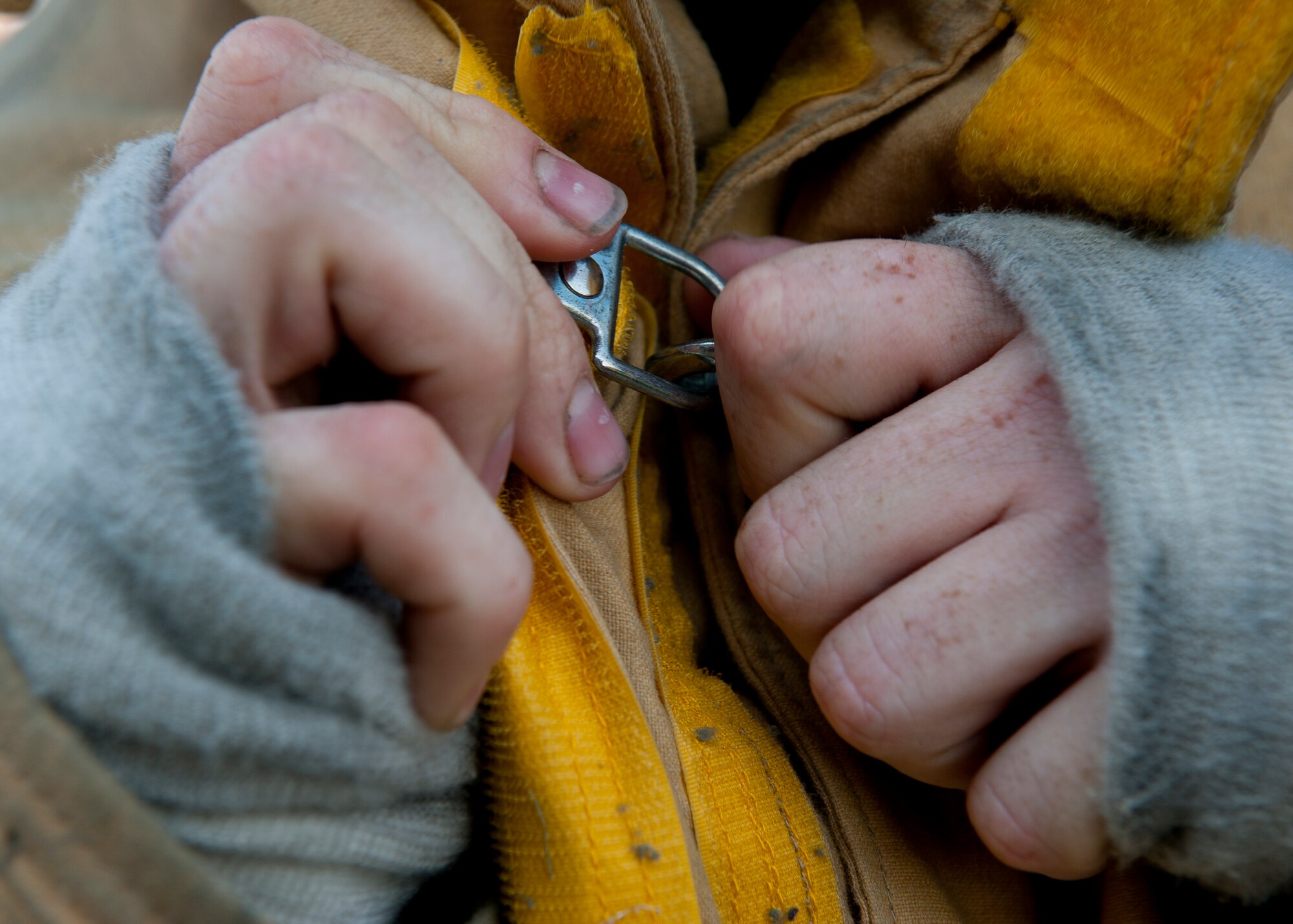 Engineer Squadron crew chief and team captain, adjusts his jacket during the final team practice, Aug. 13, 2012, at Langley Air Force Base, Va.  During the upcoming Firefighter Combat Challenge, teams will perform a series of five events including climbing a five-story tower, simulated chopping, dragging hoses and rescuing a life-sized, 175-pound mannequin as they race against the clock. (U.S. Air Force photo by Senior Airman John Strong/Released)