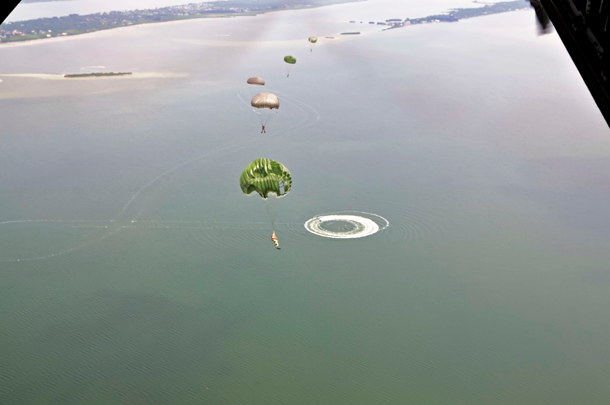 PATRICK AIR FORCE BASE, Fla.-- Pararescuemen from the 920th Rescue Wing, Patrick Air Force Base, Fla., perform static line jumps from a C-130 during a training exercise held here at local drop zone Aug. 5, 2012. Pararescuemen are highly trained in parachuting, mountaineering, SCUBA and as emergency trauma specialists.  This extensive training enables PJs to perform life-saving missions throughout the world in remote locations and under adverse conditions. (U.S. Air Force photo/Master Sgt. John Schiller)