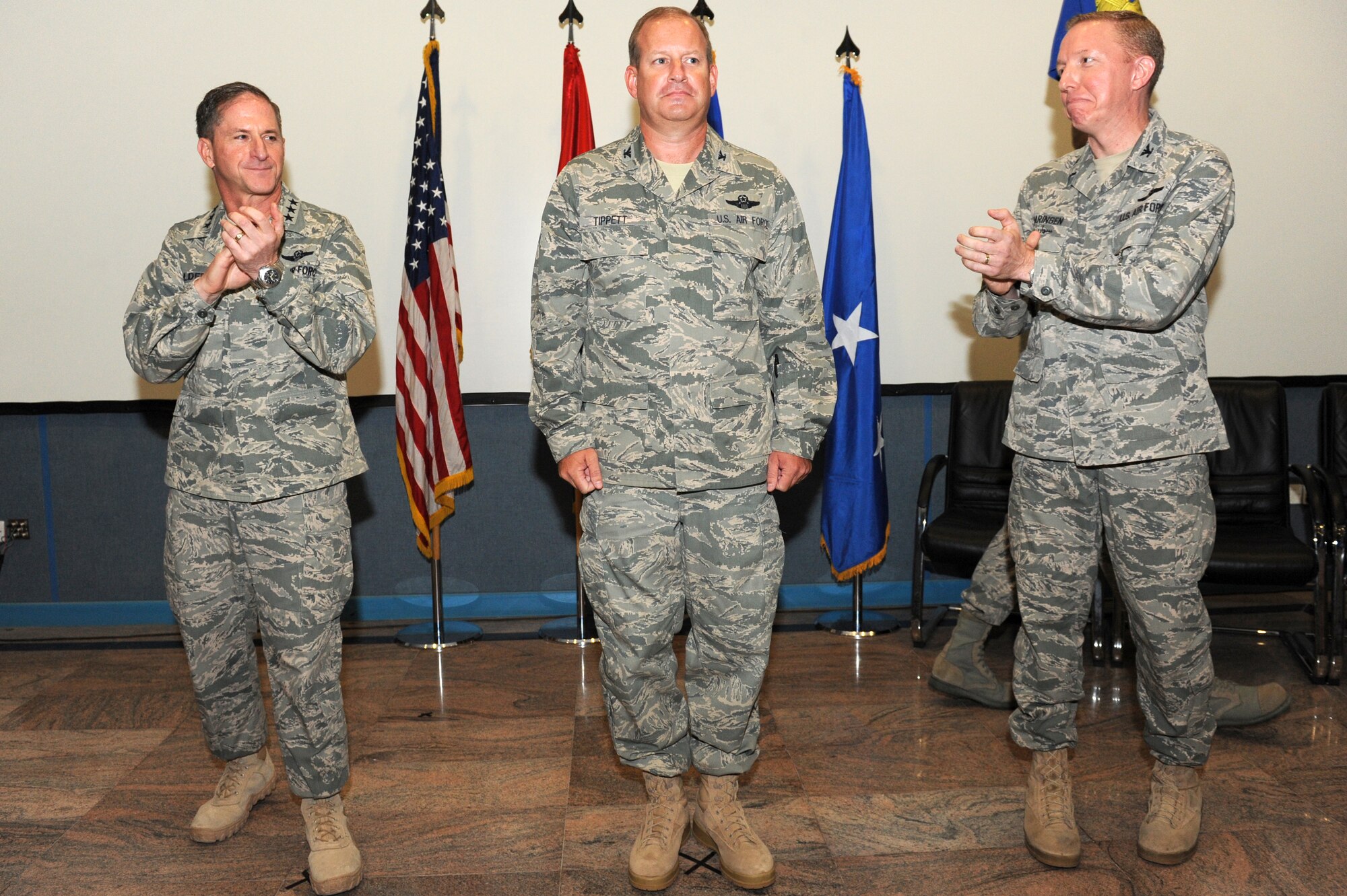 SOUTHWEST ASIA - U.S. Air Force Lt. Gen. David Goldfein, U.S. Air Forces Central Command and Combined Forces Air Component Commander, and Col. Robert Swaringen, AFCENT Air Warfare Center's outgoing commander, applaud as Col. Daniel Tippet assumes command Aug. 15, 2012. Tippet replaced Swaringen as AFCENT AWC's commander.  (U.S. Air Force photo/Master Sgt. Scott MacKay)