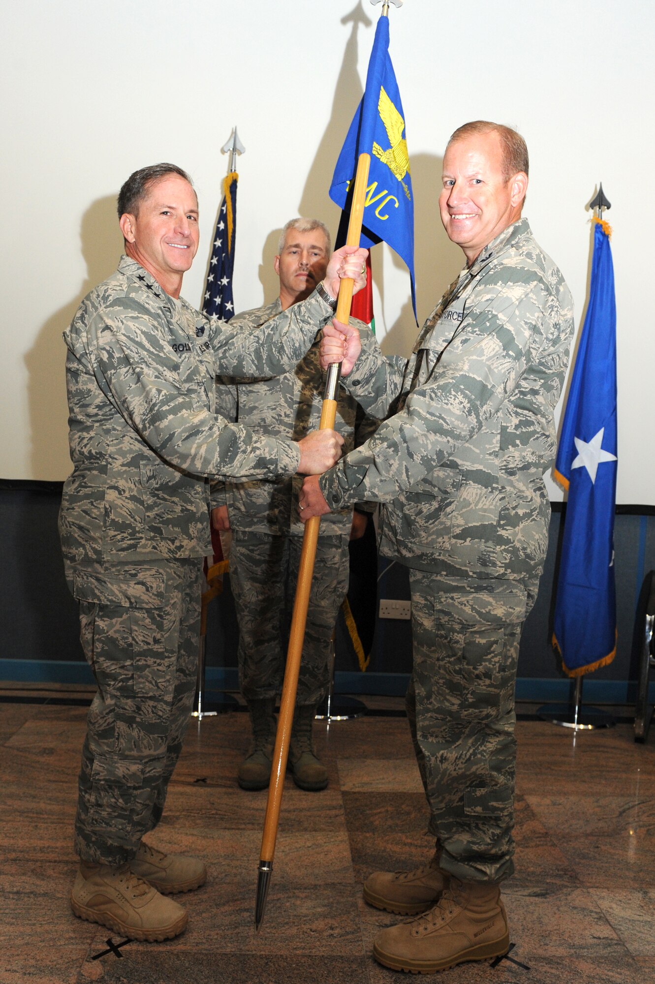 SOUTHWEST ASIA - U.S. Air Force Lt. Gen. David Goldfein, U.S. Air Forces Central Command and Combined Forces Air Component Commander, passes the AFCENT Air Warfare Center's guidon to Col. Daniel Tippet during a change of command ceremony Aug. 15, 2012. Tippet replaced Col. Robert Swaringen as AFCENT's AWC commander. (U.S. Air Force photo/Master Sgt. Scott MacKay)