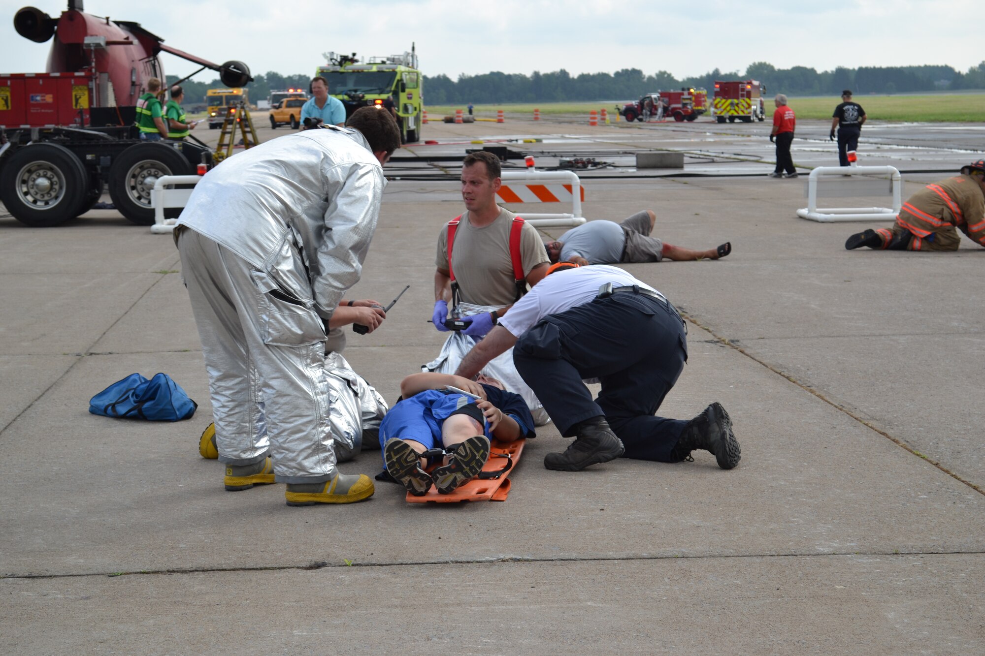 Personnel from Hancock Field Air National Guard Base, Syracuse, New York treat simulated casulaties as part of a large scale Tri-County Major Accident Response Exercise (MARE) held on 11 August 2012.The exercise involved two simultaneous exercise events, a building collapse, simulated chemical spill and bomb search in downtown Syracuse and a simulated plane crash and fire at Syracuse Hancock International Airport. (Photo by New York Air National Guard Lt. Col. Catherine Hutson/Released)