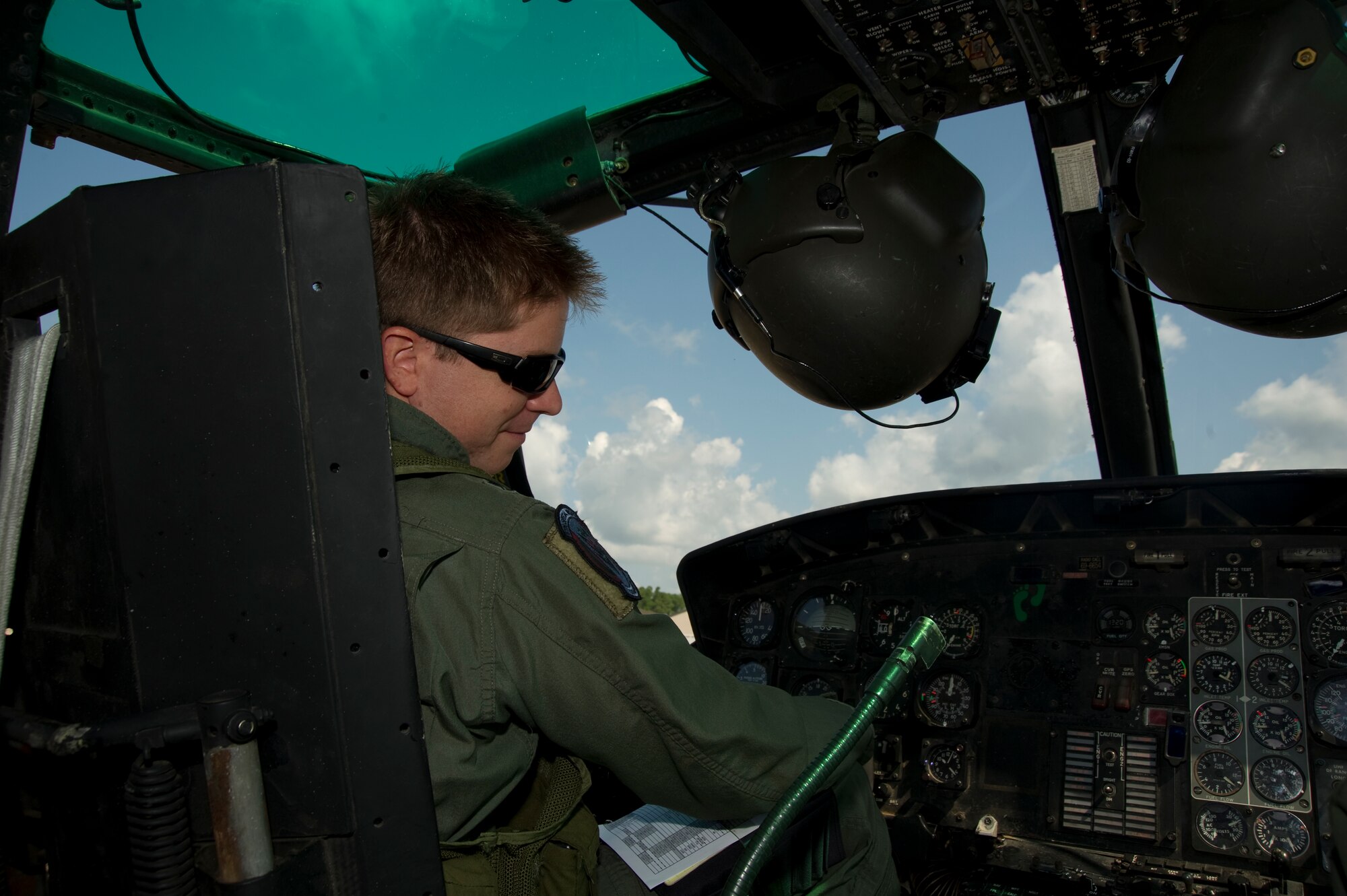 U.S. Air Force Capt. James Rankin, a combat aviation adviser of 6th Special Operations Squadron, sits in the cockpit of a UH-1N Huey on the flightline on Hurlburt Field, Fla., Aug. 13.  Squadron advisers possess specialized capabilities for foreign internal defense, unconventional warfare and coalition support.  (U.S. Air Force Photo/Airman 1st Class Naomi M. Griego)