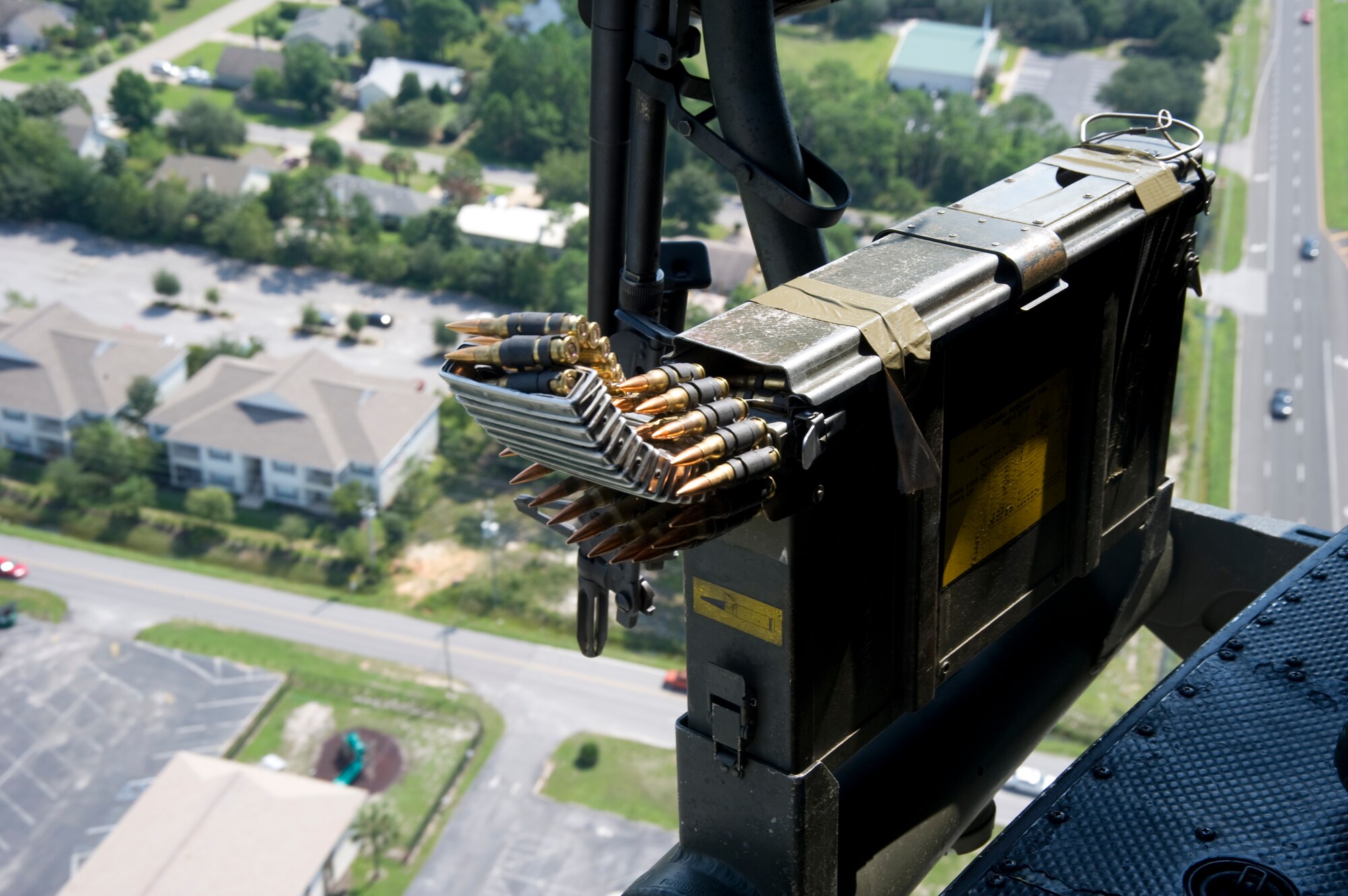 An ammo can hangs on the side of a UH-1N Huey over Fort Walton Beach, Fla., Aug. 13, 2012. The UH-1N is a light-lift utility helicopter used to support varied uses.  (U.S. Air Force Photo/Airman 1st Class Naomi M. Griego)