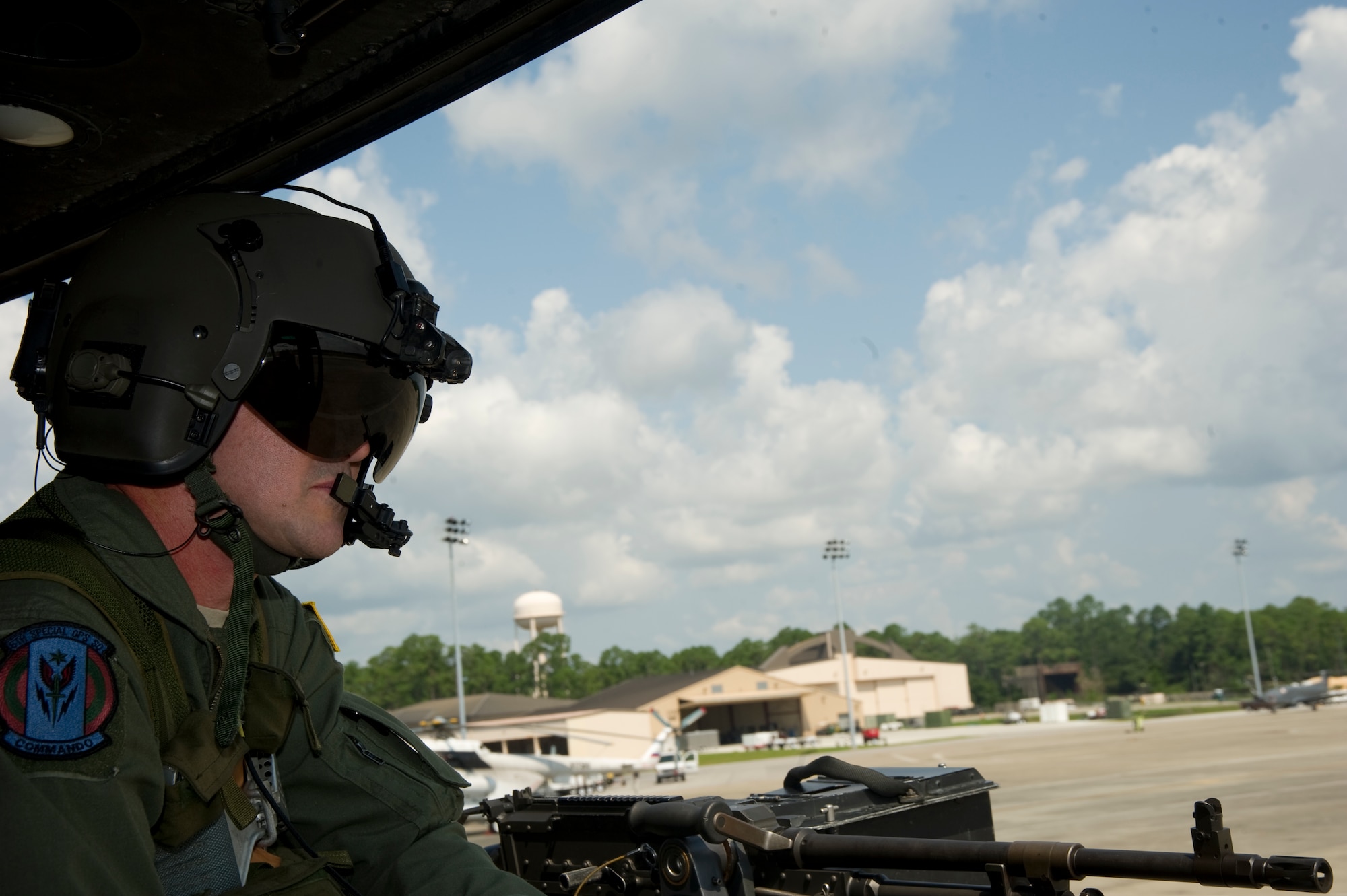 U.S. Air Force Senior Master Sgt. Clint Grizzell, operations superintendent of 6th Special Operations Squadron, looks out the side of a UH-1N Huey on the flight line of Hurlburt Field, Fla., Aug. 13, 2012. The 6th SOS is a combat aviation advisory unit with a mission to assess, train, advise and assist foreign aviation forces in airpower employment, sustainment and force integration. (U.S. Air Force Photo/Airman 1st Class Naomi M. Griego) 