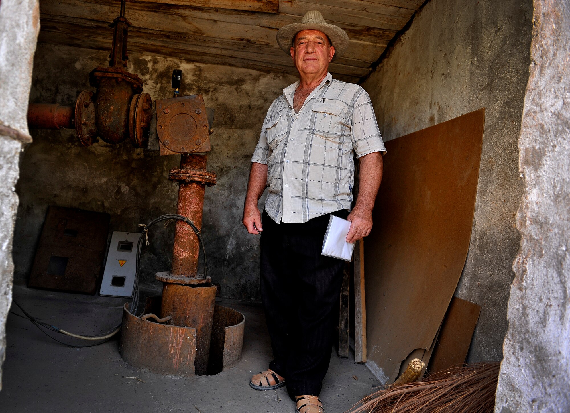 A local Kyrgyzstan elder escorts U.S. Air Force Theater Security Cooperation members and civilian personnel to four waterpump sites that are in dire need of repair or replacement, Jany-Jher, Kyrgyzstan, August 5, 2012. Manas's TSC has a two-fold mission: to positively influence political leaders and to strengthen democracy in the region. The TSC here is completely ran by U.S. Air Force personnel.(U.S. Air Force photo by Staff Sgt. Clay Lancaster)(Released)