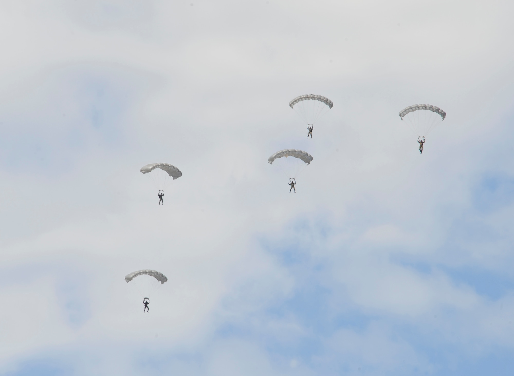 High-altitude, low-opening paratroopers float to the ground after jumping from a C-130J Super Hercules at an altitude of approximately 10,500 feet, Aug. 15, near Alzey, Germany. Members of six NATO countries came together to trade jump tactics and techniques and got the opportunity to earn the other nation's jump wings. (U.S. Air Force photo/Airman 1st Class Trevor Rhynes)  