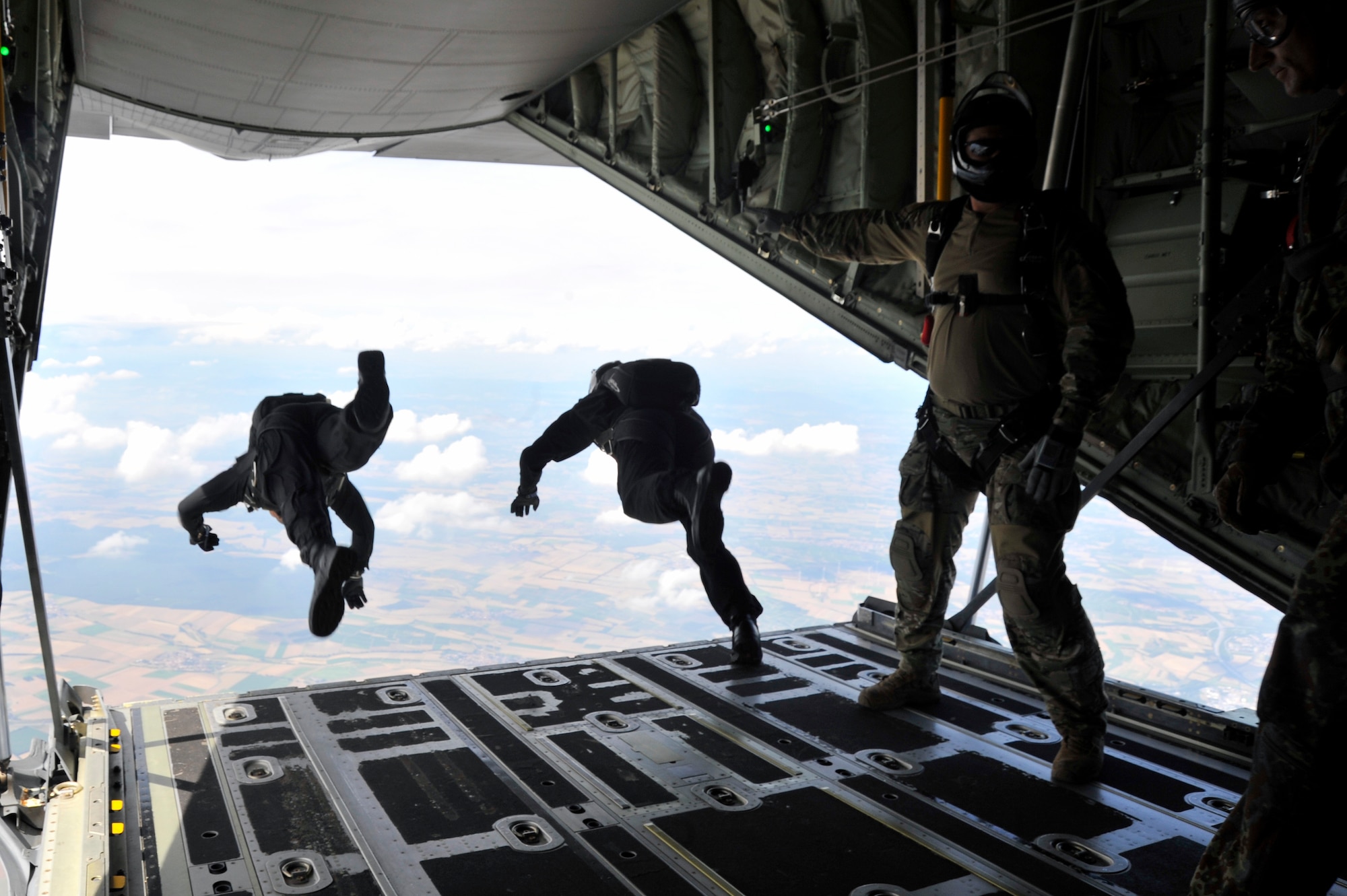 High-altitude, low-opening paratroopers from the Spanish military jump from a C-130J Super Hercules Aug. 14 near Alzey, Germany. Members of six NATO countries came together to trade jump tactics and techniques and got the opportunity to earn the other nation’s jump wings. (U.S. Air Force photo/Airman 1st Class Trevor Rhynes)