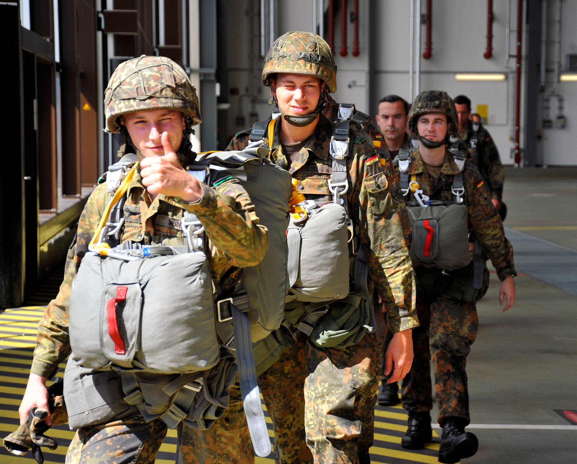 Paratroopers from the German military prepare to board a C-130J Super Hercules in preparation for a jump during International Jump Week, Aug. 14 at Ramstein Air Base, Germany.  Members of six NATO countries came together to trade jump tactics and techniques and got the opportunity to earn the other nation’s jump wings. (U.S. Air Force photo/Airman 1st Class Trevor Rhynes)