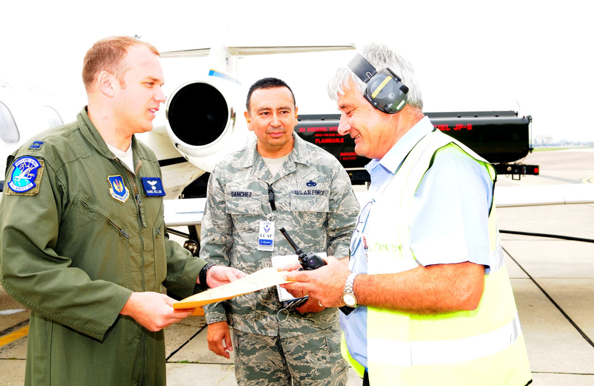 RAF MILDENHALL, England – Steve Christian, right, 727th Air Mobility Squadron inbound information controller and Ministry of Defence employee, gives an aircrew briefing on cargo upload to Capt. Daniel Helland, left, a C-21 Learjet pilot from Ramstein Air Base, Germany, Aug. 15, 2012, at RAF Mildenhall. Logistics Compliance Assessment Program inspector Master Sgt. Ray Sanchez, 621st West Wing, Travis Air Force Base, Calif., assessed Christian and others in the air terminal operations center, passenger services and fleet services sections. The 727th AMS, along with the 100th Maintenance Group and 100th Logistics Readiness Squadron, are currently undergoing an LCAP inspection to ensure they are accomplishing daily tasks and duties in accordance with Air Force regulations and guidance. (U.S. Air Force photo/Karen Abeyasekere)