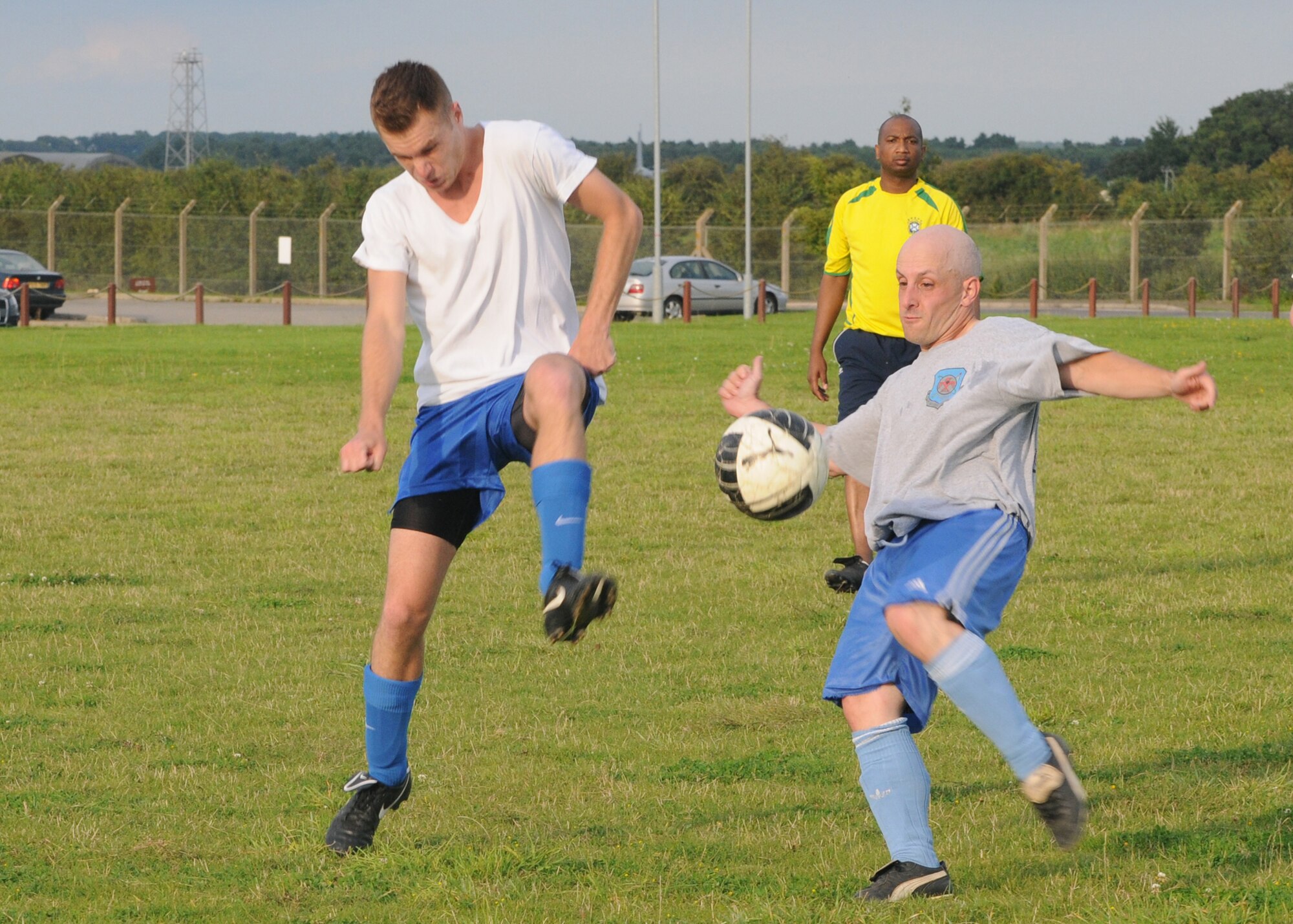 RAF MILDENHALL, England –Marco Misko, left, 100th Civil Engineer Squadron, and Larry Ballinger, 100th Logistics Readiness Squadron, fight for control of the ball during an intramural soccer match at RAF Mildenhall Aug. 14, 2012. The 100th LRS won the match 1 – 0. (U.S. Air Force photo by Tech. Neal X. Joiner)