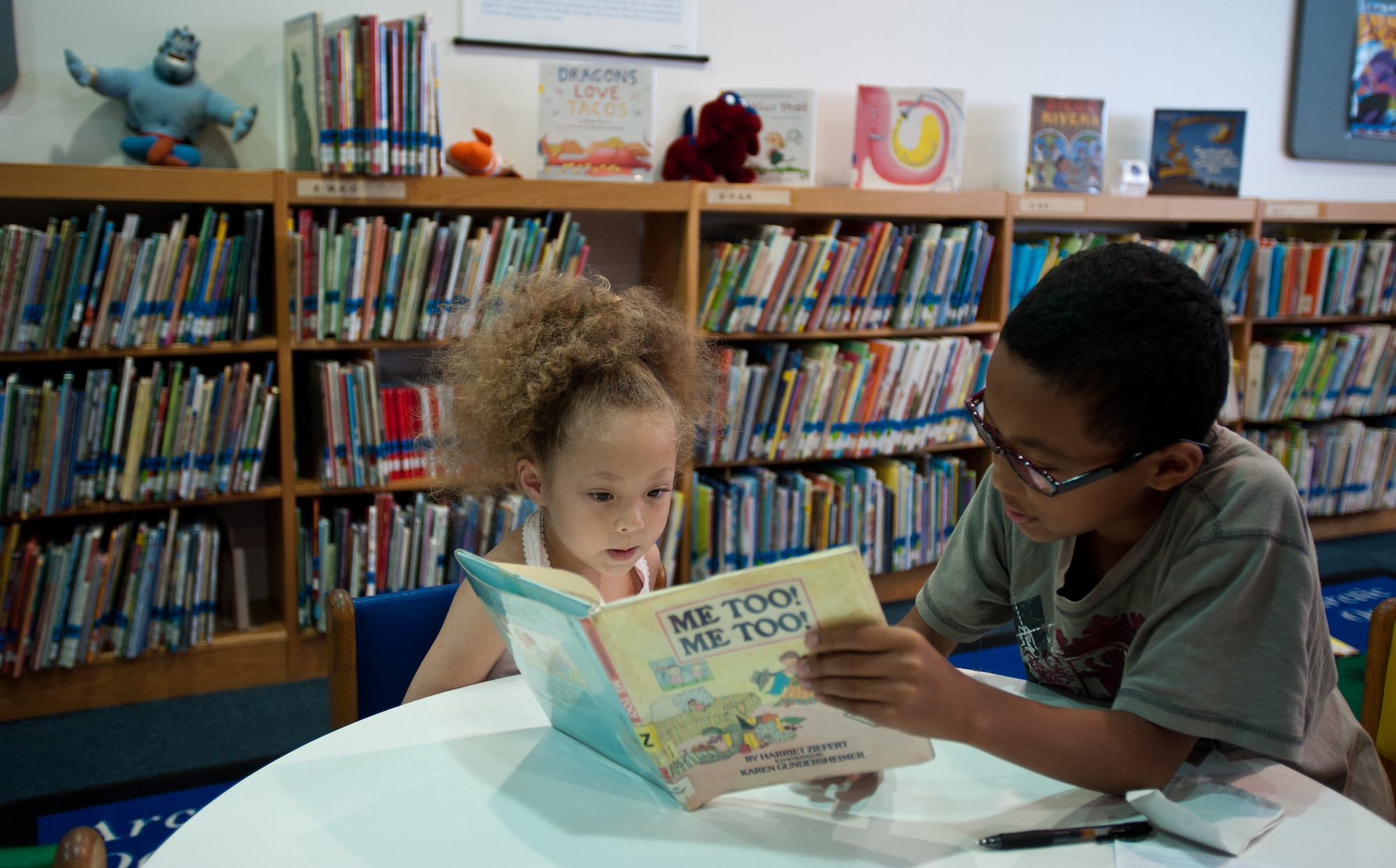 YOKOTA AIR BASE, Japan -- Tony Harris, right, reads to his sister, Akira Harris at the Base Library at Yokota Air Base, Japan, on Aug. 15, 2012. The library hosts a summer reading program every year from June to August to encourage children to read. (U.S. Air Force photo by Airman 1st Class John D. Partlow)