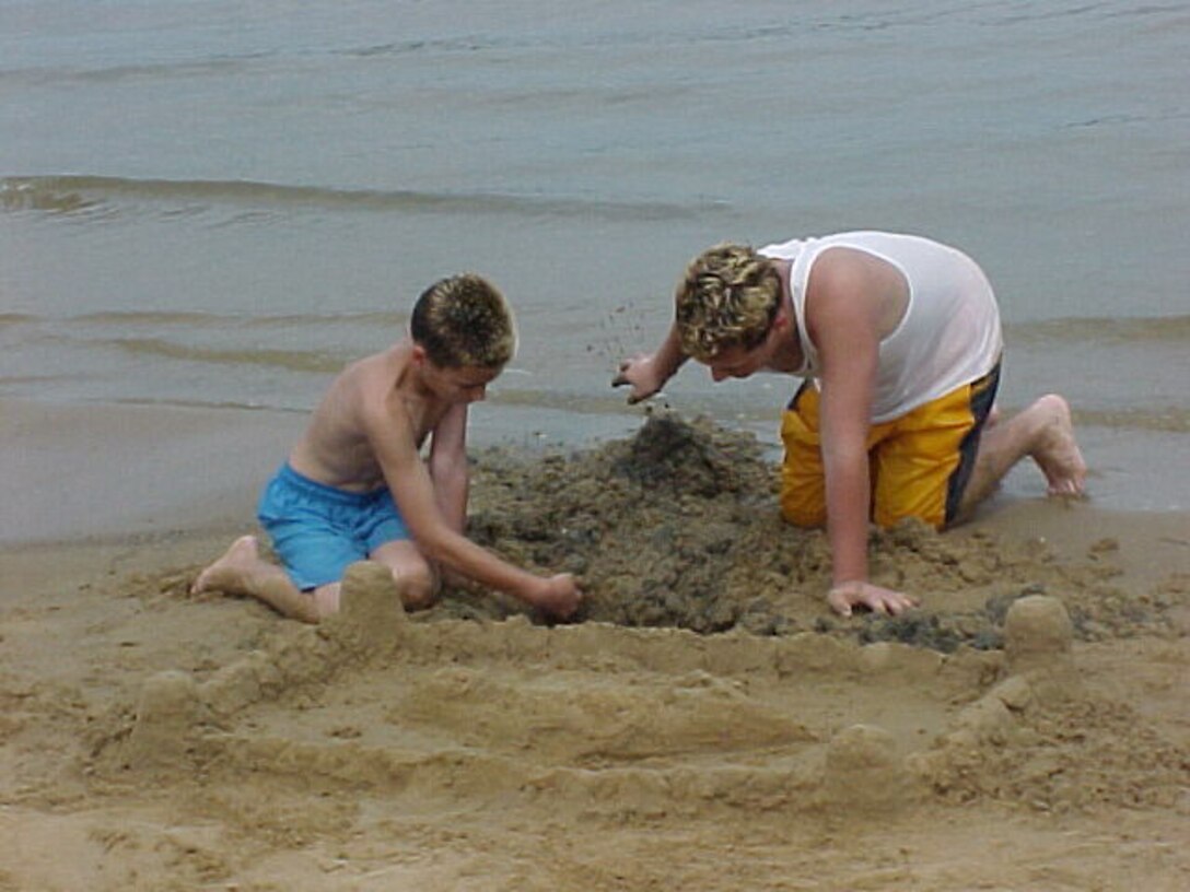 Boys digging for treasure and building sand castles at Taylor Ferry Beach on Fort Gibson Lake.