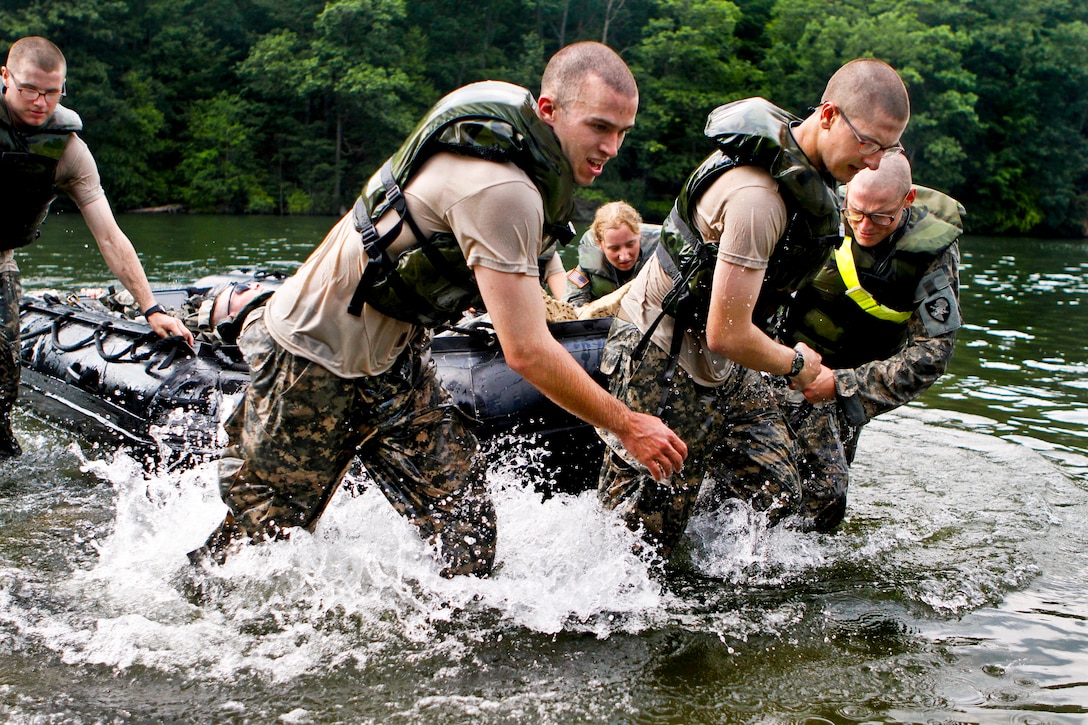 Cadets rush to get their Zodiac raft with all their equipment out of the water after crossing Lake Popolopen during Steele Challenge on Camp Buckner at the U.S. Military Academy at West Point, N.Y., Aug. 9, 2012.