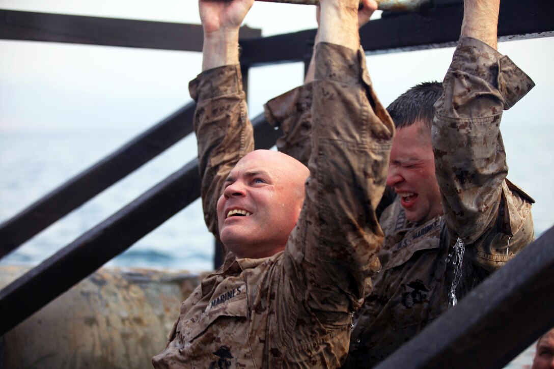 U.S. Marine Cpl.'s Travis Bryant, front, and John Kelley, back, navigate through a water obstacle course on Arta Beach in Djibouti, Aug. 11, 2012. Bryant and Kelley are assigned to the 2nd Marine Regiment, 24th Marine Expeditionary Unit.