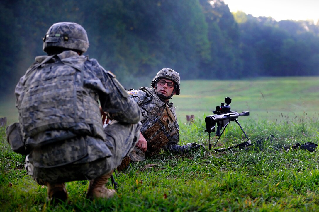 Army Staff Sgt. Christopher Thompson, front, discusses shooting strategy with his spotter, Sgt. Matthew Bagley, during the first 20th Support Command's competition for Explosive Ordnance Disposal Team of the Year on Fort Knox, Ky., Aug. 15, 2012. Thompson, a team leader, and Bagley are assigned to the 663rd Ordnance Company, 242nd Explosive Ordnance Disposal Battalion, Fort Carson, Colo.