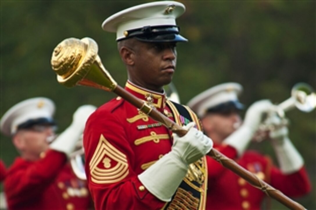 Marine Corps Master Gunnery Sgt. Kevin Buckles directs his musicians during a sunset parade at the Marine Corps War Memorial in Arlington, Va., Aug. 14, 2012. Buckles is a Marine Drum & Bugle Corps drum major. 