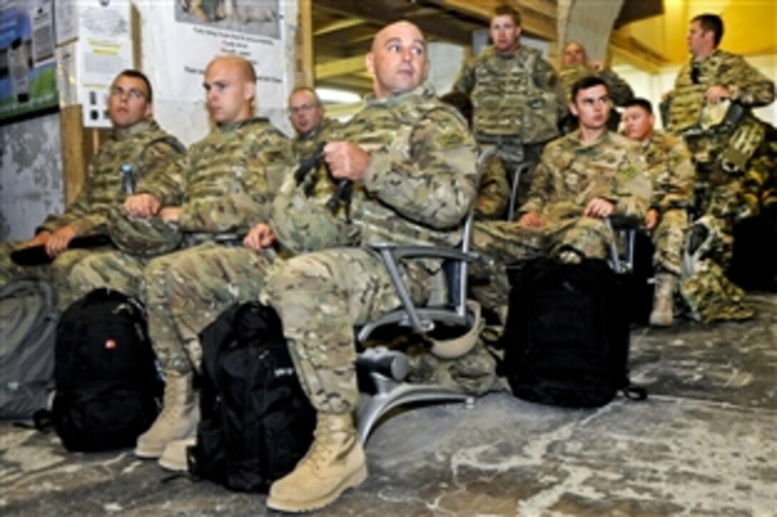 U.S. airmen assemble to begin in-processing at the incoming terminal at Kandahar Airfield, Afghanistan, Aug. 10, 2012. The airmen are assigned to the Minnesota Air National Guard's 148th Fighter Wing. The airmen will take over flying missions and provide close air support for troops on the ground in Afghanistan.