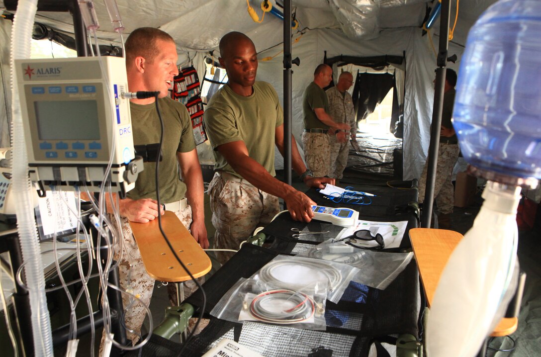 Petty Officer 3rd Class Brandon Clark and Petty Officer 2nd Class Donald Dalizu, surgical technicians with 2nd Medical Battalion, 2nd Marine Logistics Group, test some of their surgical equipment in a Forward Resuscitative Surgical System set up aboard Camp Lejeune, N.C., Aug. 15, 2012. Improvements to the medical equipment used by the FRSS have increased its power requirements, and a team of engineers and medical personnel spent a week determining the amount of energy needed to sustain its operations. 