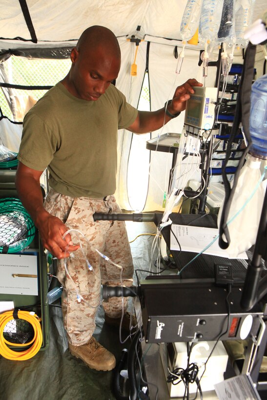 Petty Officer 2nd Class Donald Dalizu, a surgical technician with 2nd Medical Battalion, 2nd Marine Logistics Group, tests an infusion pump at a Forward Resuscitative Surgical System set up aboard Camp Lejeune, N.C., Aug. 15, 2012. The FRSS serves as a mobile medical facility capable of stabilizing casualties near the fight. Improvements to its equipment have increased its energy demands, and engineers and medical personnel spent a week determining the facility’s new energy needs. 