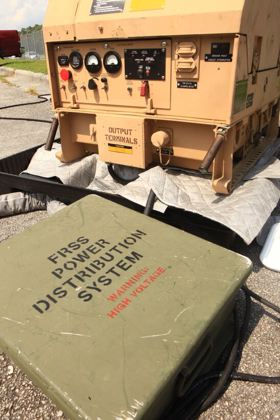A portable 3000-watt generator and distribution system stands near a Forward Resuscitative Surgical System set up by Medical Supply Company, 2nd Marine Logistics Group aboard Camp Lejeune, N.C., to test the power requirements of its medical equipment Aug. 15, 2012. The FRSS is a mobile medical treatment facility capable of quickly stabilizing casualties close to the fight. Improvements to its existing equipment have increased its demand for energy. 