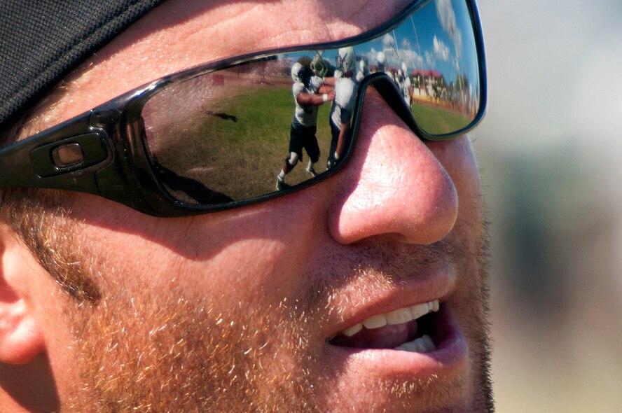 Chris Wiesehan, University of Hawaii offensive line and run game coordinator, works with the offensive line during blocking drills Aug. 17 at Earhart Field, Joint Base Pearl Harbor-Hickam, Hawaii. The team lived and worked out on Hickam Field from Aug. 13-17 due to the UH dormitories being cleaned and prepared for the start of the fall session. The Warriors are scheduled to be on the road for their opener Sept. 1, in Los Angeles, against the University of Southern California Trojans. (U.S. Air Force photo/Staff Sgt. Mike Meares)