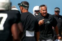 Norm Chow, University of Hawaii head coach, directs an Aug. 15 Warriors practice at Earhart Field, Joint Base Pearl Harbor-Hickam, Hawaii. The team lived and worked out on Hickam Field from Aug. 13-17 due to the UH dormitories being cleaned and prepared for the start of the fall session. The Warriors are scheduled to be on the road for their opener Sept. 1, in Los Angeles, against the University of Southern California Trojans. (U.S. Air Force photo/Staff Sgt. Mike Meares)