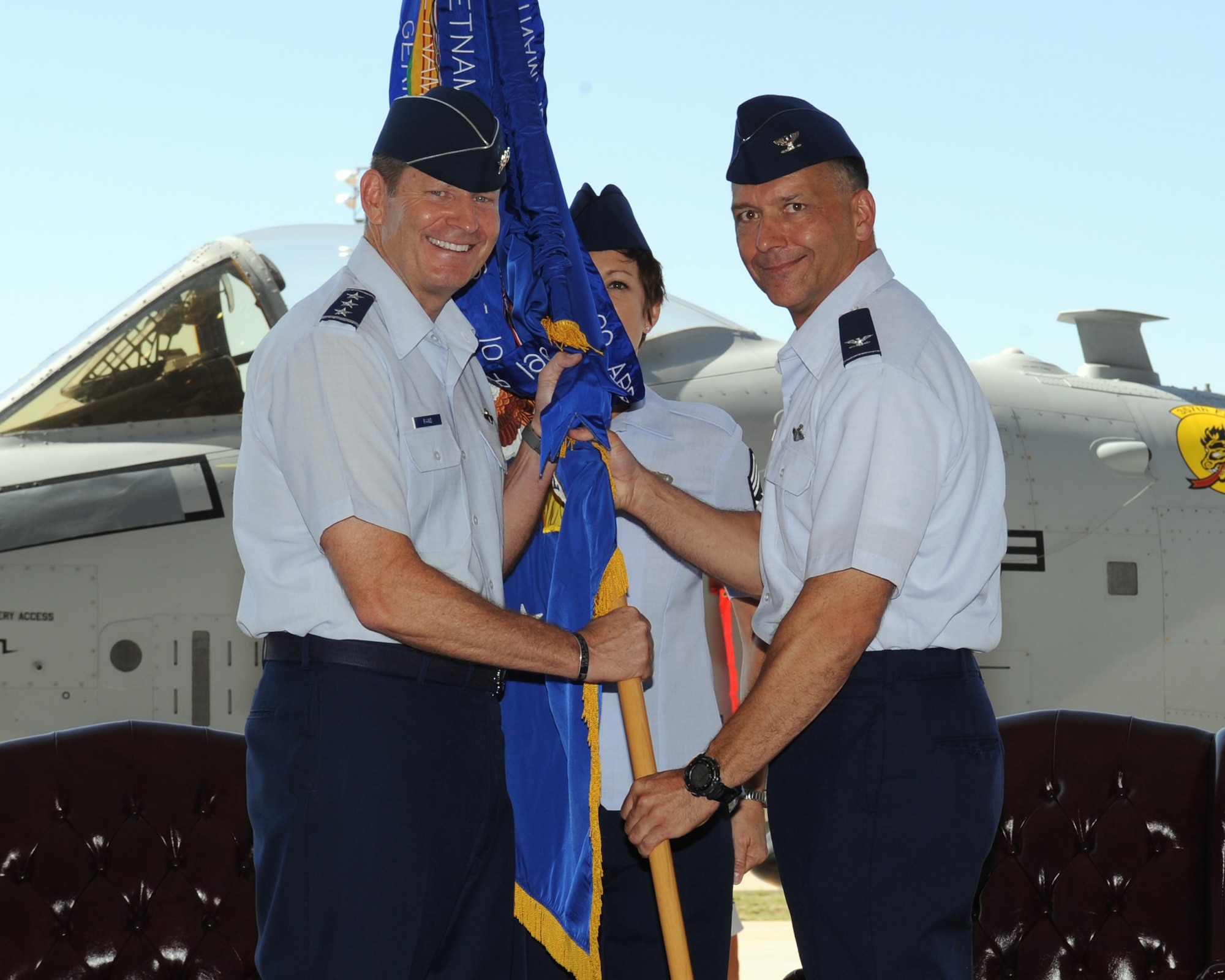 U.S. Air Force Lt. Gen. Robin Rand, 12th Air Force (Air Forces Southern) commander, hands the 355th Fighter Wing guidon to Col. Kevin Blanchard as he assumes command on Davis-Monthan Air Force Base, Ariz. Aug. 10, 2012. Colonel Blanchard comes to D-M from the vice-commander seat of the 451st Air Expeditionary Wing at Kandahar Airfield, Afghanistan. (U.S Air Force photo by Airman 1st Class Timothy D. Moore/Released)