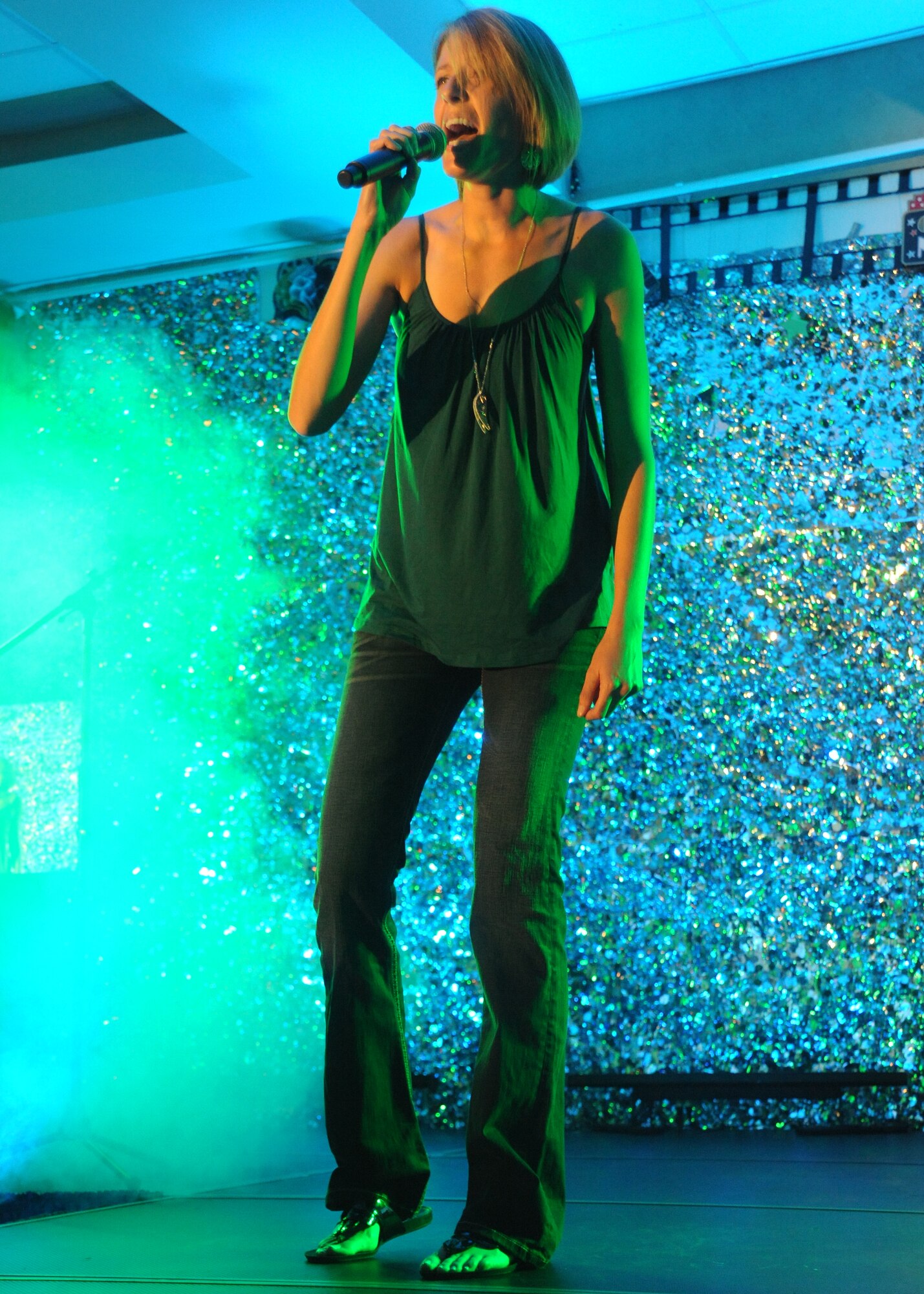 Maj. Sarah McElhenny, commander of the 319th Contracting Squadron, sings “Call Me” by Blondie at the Air Mobility Command Icon competition, Aug. 16, 2012, on Grand Forks Air Force Base, N.D. Thirteen military community vocalists participated in this year’s Grand Forks AFB AMC Icon. (U.S. Air Force photo/Airman 1st Class Xavier Navarro)