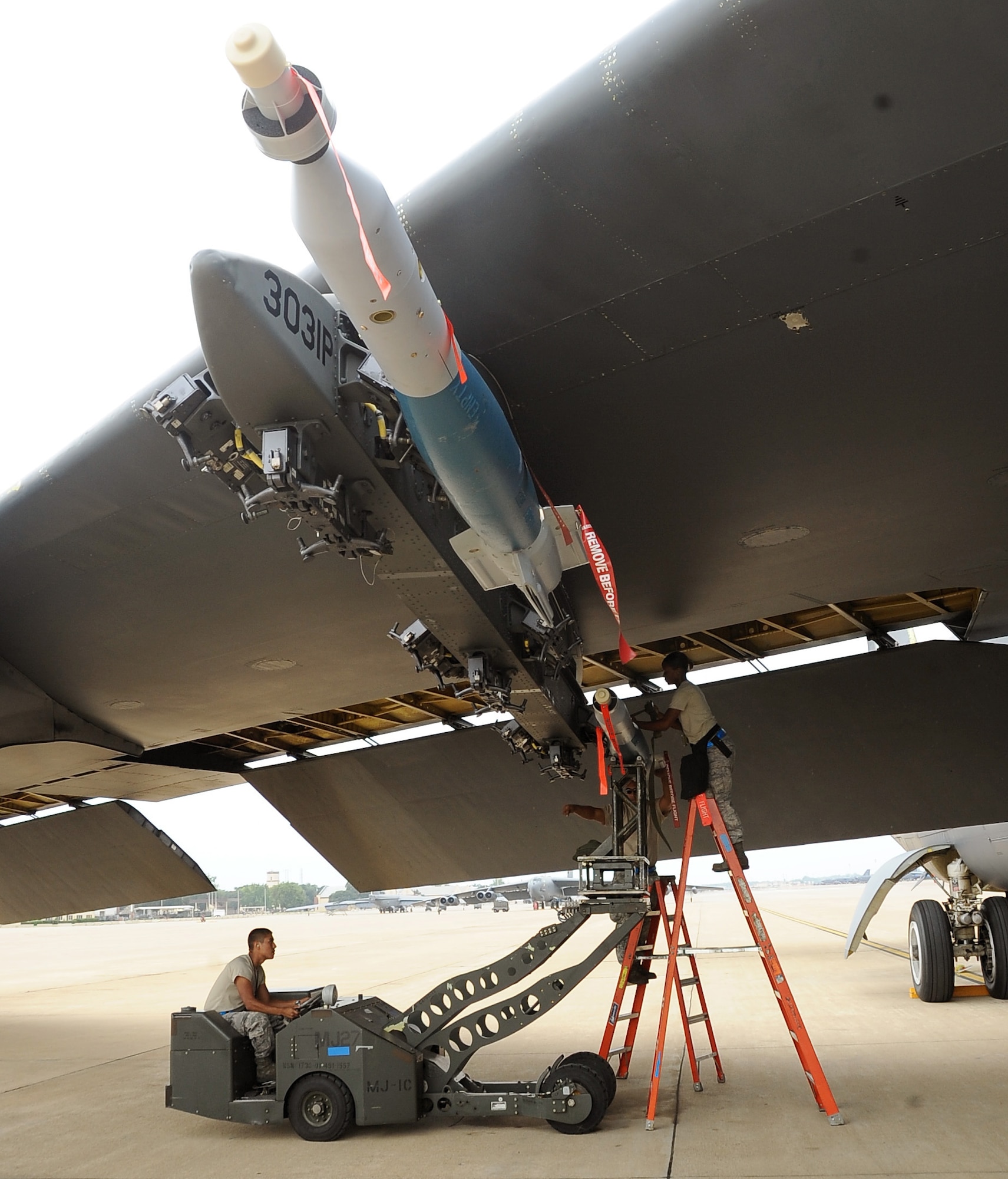Weapons loaders from the 2nd Maintenance Operations Squadron attach GBU-12s to a B-52H Stratofortress on Barksdale Air Force Base, La., Aug. 15. The munitions were being loaded to be dropped at a bombing range in Utah for Exercise Combat Hammer. The exercise evaluates the employment of precision guided munitions to ensure the weapons are fully functional and mission capable. (U.S. Air Force photo/Staff Sgt. Amber Ashcraft)(RELEASED)