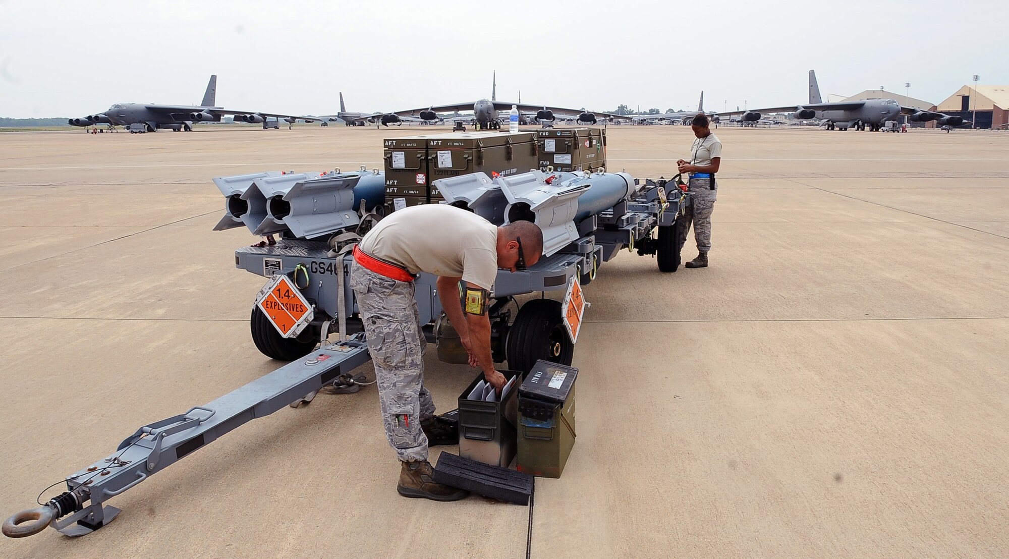 Weapons loaders from the 2nd Maintenance Operations Squadron prepare munitions for loading on Barksdale Air Force Base, La., Aug. 15. The munitions were being loaded onto a B-52H Stratofortress to be dropped at a bombing range in Utah for Exercise Combat Hammer. The exercise evaluates the employment of precision guided munitions to ensure the weapons are fully functional and mission capable. (U.S. Air Force photo/Staff Sgt. Amber Ashcraft)(RELEASED)
