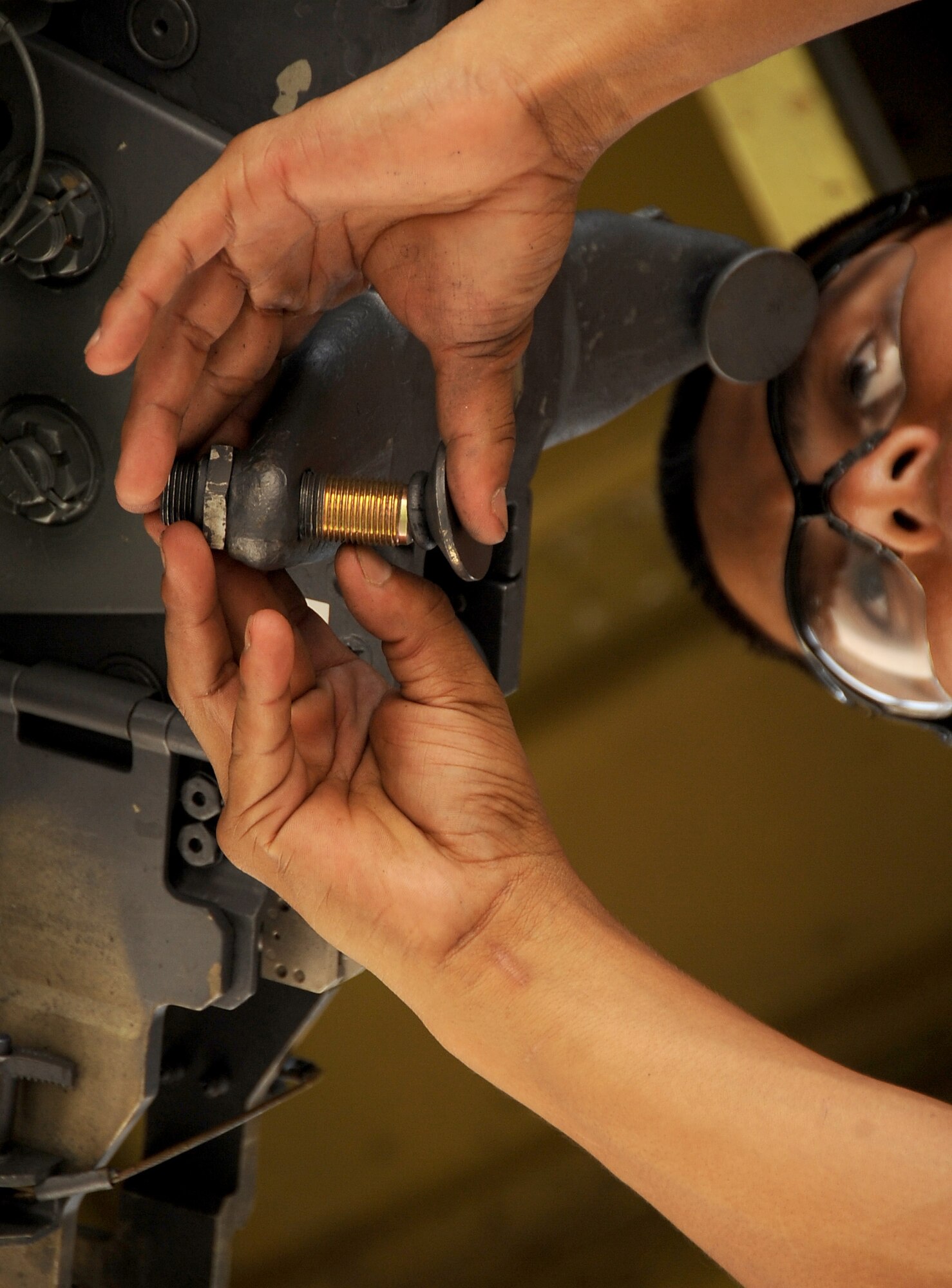 A weapons loader from the 2nd Maintenance Operations Squadron counts the threads on a bolt of a heavy storage adapter beam under the wing of a B-52H Stratofortress on Barksdale Air Force Base, La., Aug. 15. The bolts must be prepared prior to attaching munitions to the beam, so that once the bomb is lifted, it can be quickly secured. The munitions were being loaded onto a B-52 to be dropped at a bombing range in Utah for Exercise Combat Hammer. The exercise evaluates the employment of precision guided munitions to ensure the weapons are fully functional and mission capable. (U.S. Air Force photo/Staff Sgt. Amber Ashcraft)(RELEASED)