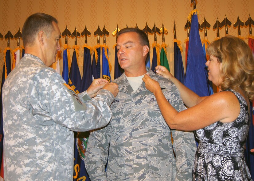 Newly promoted Brig. Gen. David W. Newman, gets “pinned” Sunday by his wife, Karen, and by Maj. Gen. Stephen L. Danner, adjutant general of the Missouri National Guard, August 11. Newman serves as chief of the Missouri National Guard Joint Staff. (National Guard photo by Bill Phelan) 