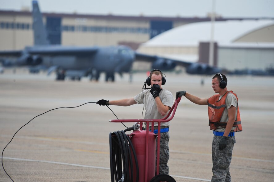 Senior Airman Bryan Turner, 2nd Aircraft Maintenance Squadron crew chief, communicates with aircrew members as Airman 1st Class Logan Turner, 2 AMXS crew chief, stands by on Barksdale Air Force Base, La., Aug. 15. Aircrews from Barksdale participated in Exercise Combat Hammer, which evaluated the employment of precision guided munitions to ensure the weapons are fully functional and mission capable. The exercise tested aircrews, munitions and maintenance Airmen on their performance. (U.S. Air Force photo/Airman 1st Class Micaiah Anthony)(RELEASED)