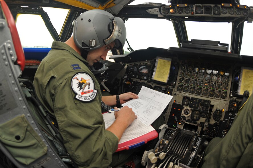 Capt. Roger Tinnin, 20th Bomb Squadron pilot, goes over the pre-flight checklist of a B-52H Stratofortress bomber on Barksdale Air Force Base, La., Aug. 15. Aircrews from Barksdale participated in Exercise Combat Hammer, which evaluated the employment of precision guided munitions to ensure the weapons are fully functional and mission capable. The exercise tested aircrews, munitions and maintenance Airmen on their performance. (U.S. Air Force photo/Airman 1st Class Micaiah Anthony)(RELEASED)