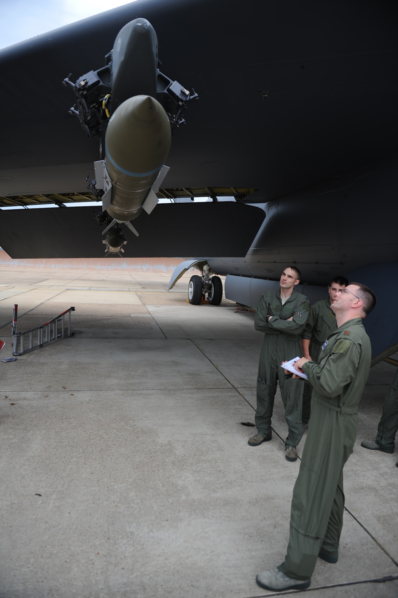 Maj. Brett Plumber, 20th Bomb Squadron radar navigator, shows aircrew members how to properly inspect munitions on Barksdale Air Force Base, La., Aug. 15. Prior to a flight, aircrews check munitions for damage and leaks and ensure the bomb is properly mounted to the aircraft. The aircrew flew to Utah to participate in Exercise Combat Hammer.  Combat Hammer evaluates the employment of precision guided munitions to ensure the weapons are fully functional and mission capable. (U.S. Air Force photo/Airman 1st Class Micaiah Anthony)(RELEASED)