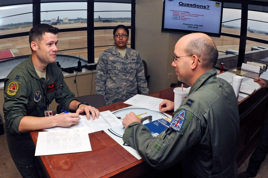 Capt. John Owens, 96th Bomb Squadron instructor radar navigator, goes through paperwork with Capt. Tony Curtis, 2nd Operations Group standards and evaluation electronic warfare officer, after a pre-mission briefing on Barksdale Air Force Base, La., Aug. 15. Aircrews from Barksdale participated in Exercise Combat Hammer. The exercise is used to evaluate the employment of precision guided munitions to ensure the weapons are fully functional and mission capable. (U.S. Air Force photo/Airman 1st Class Micaiah Anthony)(RELEASED)