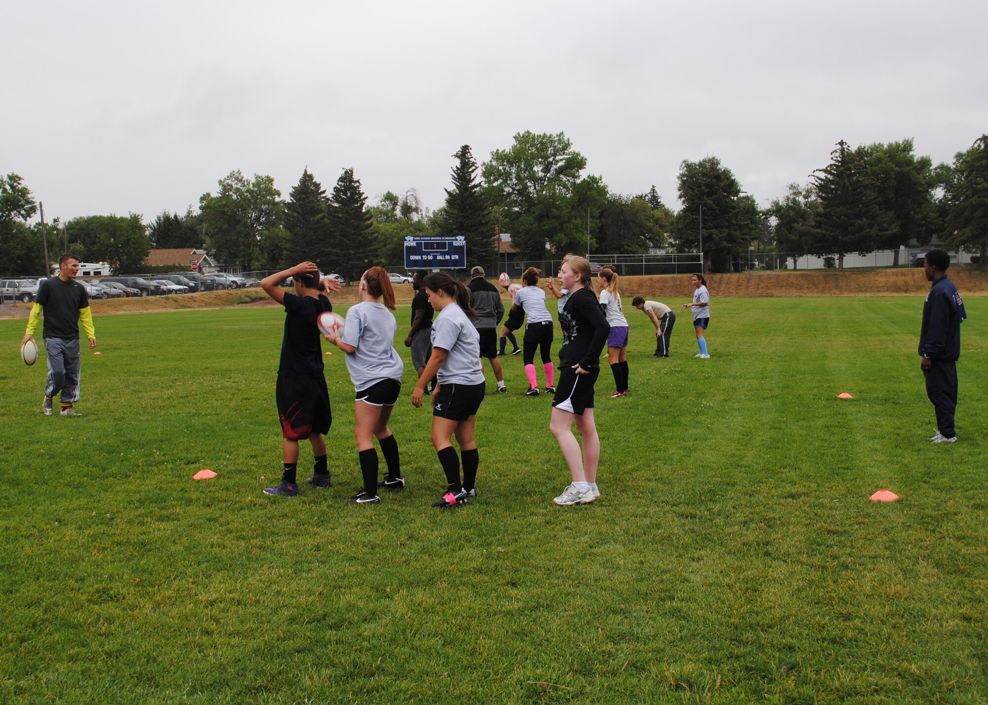 Staff Sgt. Danielle Fairhurst, 10th Missile Squadron member (far right), and her husband, Martin (far left), help coach high school boys and girls interested in playing rugby in Great Falls.  Anyone interested in volunteering as part of the rugby teams or just learning about the sport should call April McLean at 899-0680 or via email at ecrc.havocrugby@yahoo.com.  (U.S. Air Force photo/Airman 1st Class Cortney Paxton)