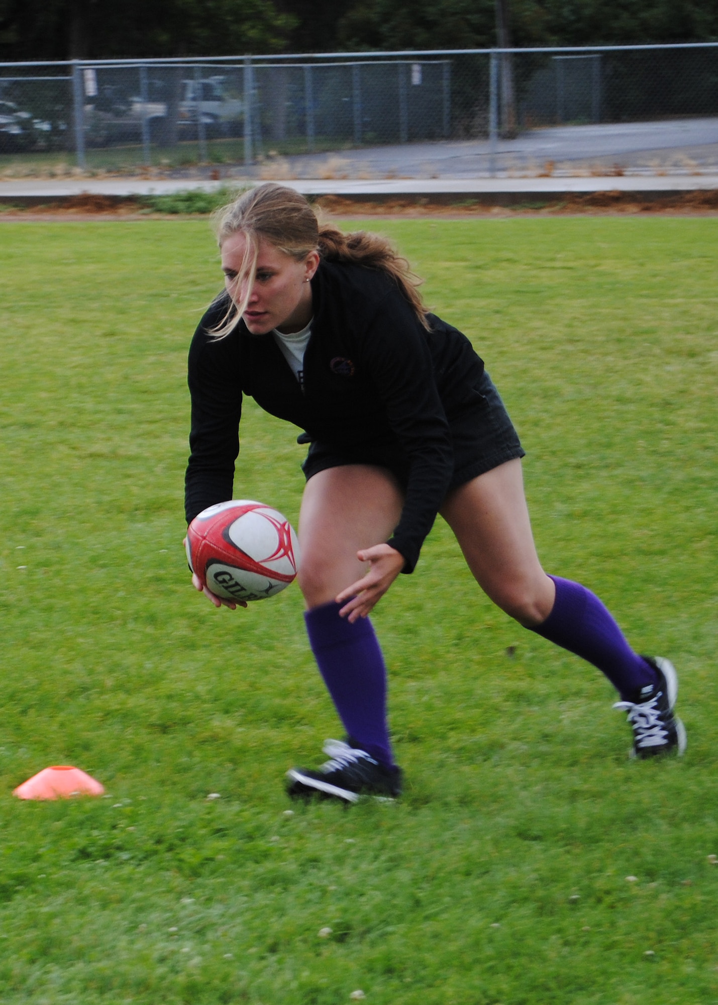 Montana Air National Guardsman Airman 1st Class Eve Dorshorst, 120th Aircraft Maintenance Squadron member, juggles a rugby ball through cones as part of an exercise during a Rugby Clinic at the Paris Gibson Education Center on Aug. 15.  Dorshorst has played on The Better Side rugby team out of Missoula since her senior year in high school.  (U.S. Air Force photo/Airman 1st Class Cortney Paxton)