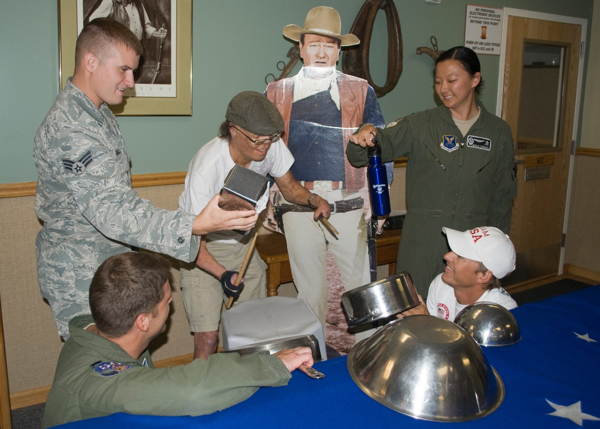 Dan Caro, drummer, uses props held by Team Malmstrom members at B-01 Missile Alert Facility to make a beat with his drumsticks for those watching nearby.  Caro plays the drums by holding one stick with a moveable thumb he received through surgery and by attaching the other stick to his arm with a wristband.  (U.S. Air Force photo/Airman 1st Class Cortney Paxton)