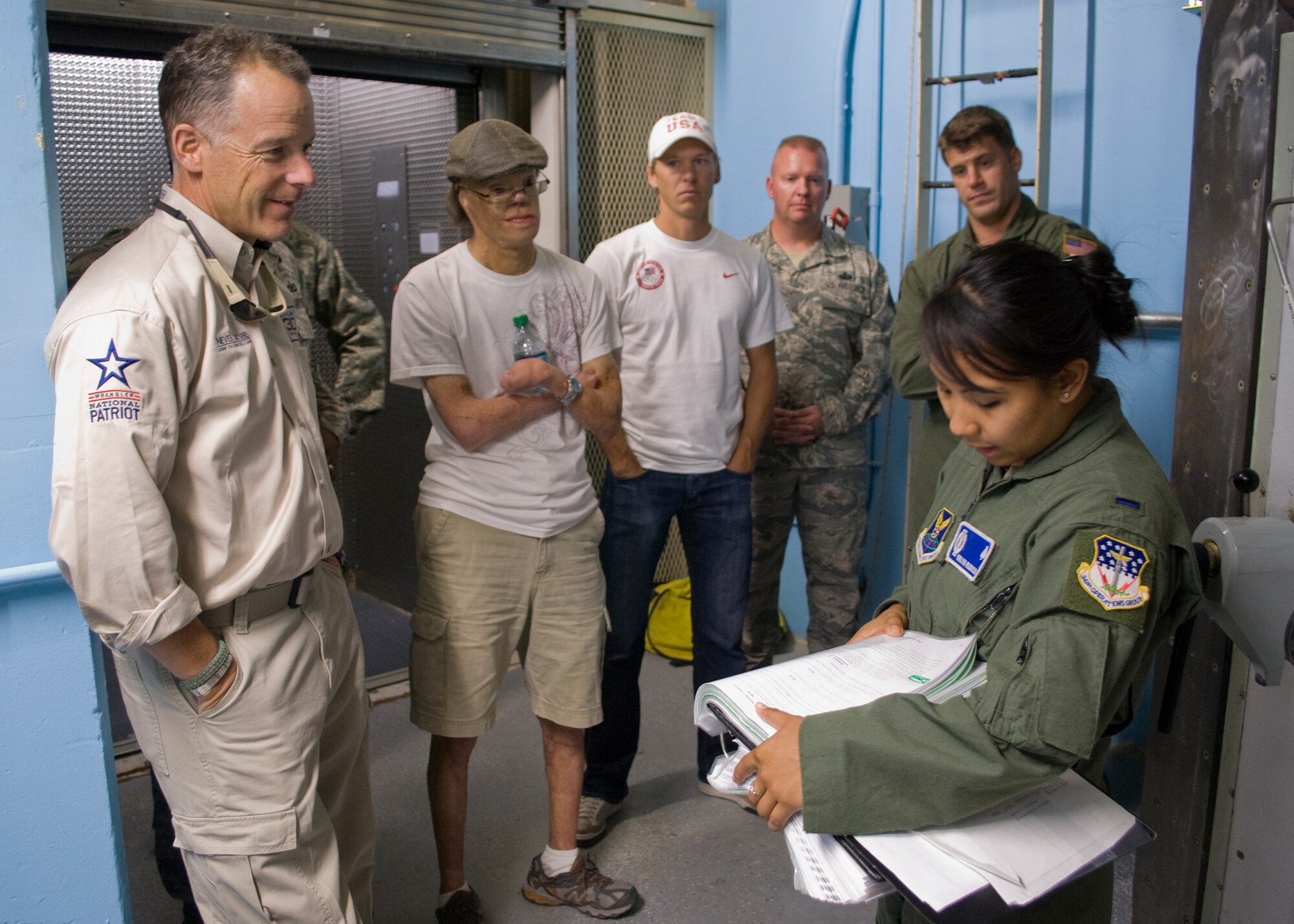 1st Lt. Erlyn Rudico, 10th Missile Squadron member (far right), gives a short safety briefing to members preparing to enter the Launch Control Center at B-02 MAF.  From left to right are Robi Powers, American300 founder; Dan Caro, drummer; Todd Lodwick, five-time Olympian; Senior Master Sgt. Jerry Hall, 341st Communications Squadron first sergeant; and Capt. Christopher Tubesing, 10th MS flight commander.  (U.S. Air Force photo/Airman 1st Class Cortney Paxton)