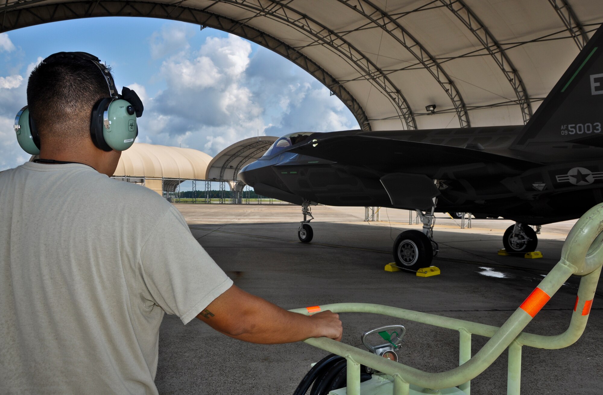 A maintainer watches the F-35A Lightning II joint strike fighter as the pilot performs shutdown procedures after a sortie at Eglin Air Force Base, Fla., Aug. 16.  (U.S. Air Force photo/Maj. Karen Roganov)